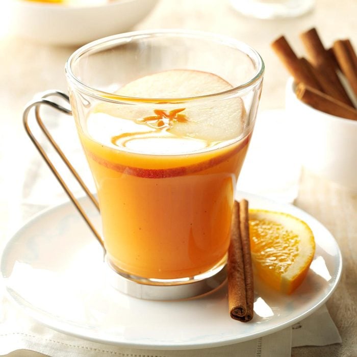 a glass of spiced orange cider