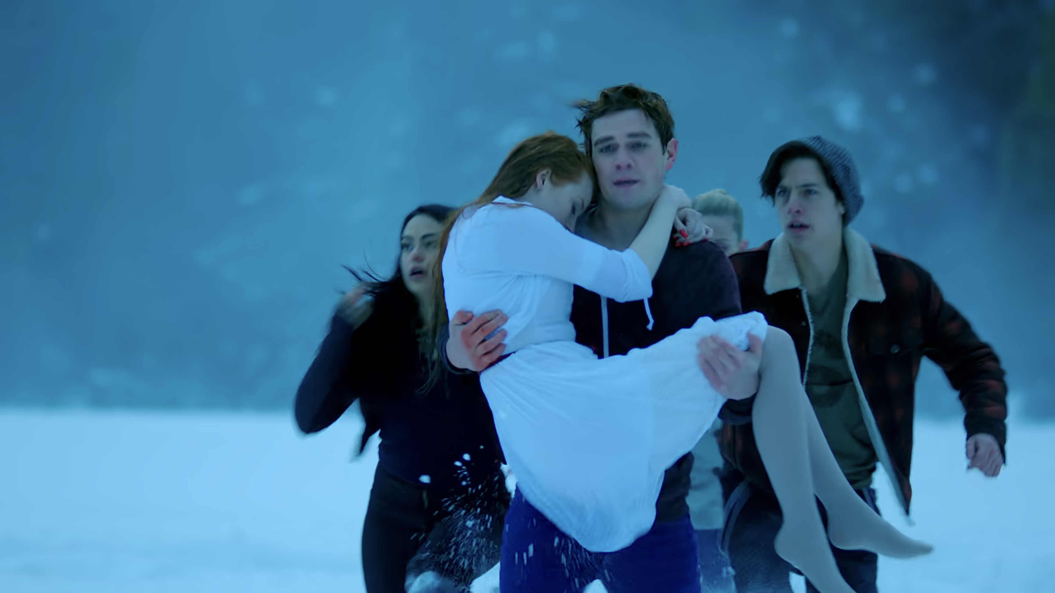 Archie carries Cheryl through the snow with Betty, Jughead, and Veronica running beside him