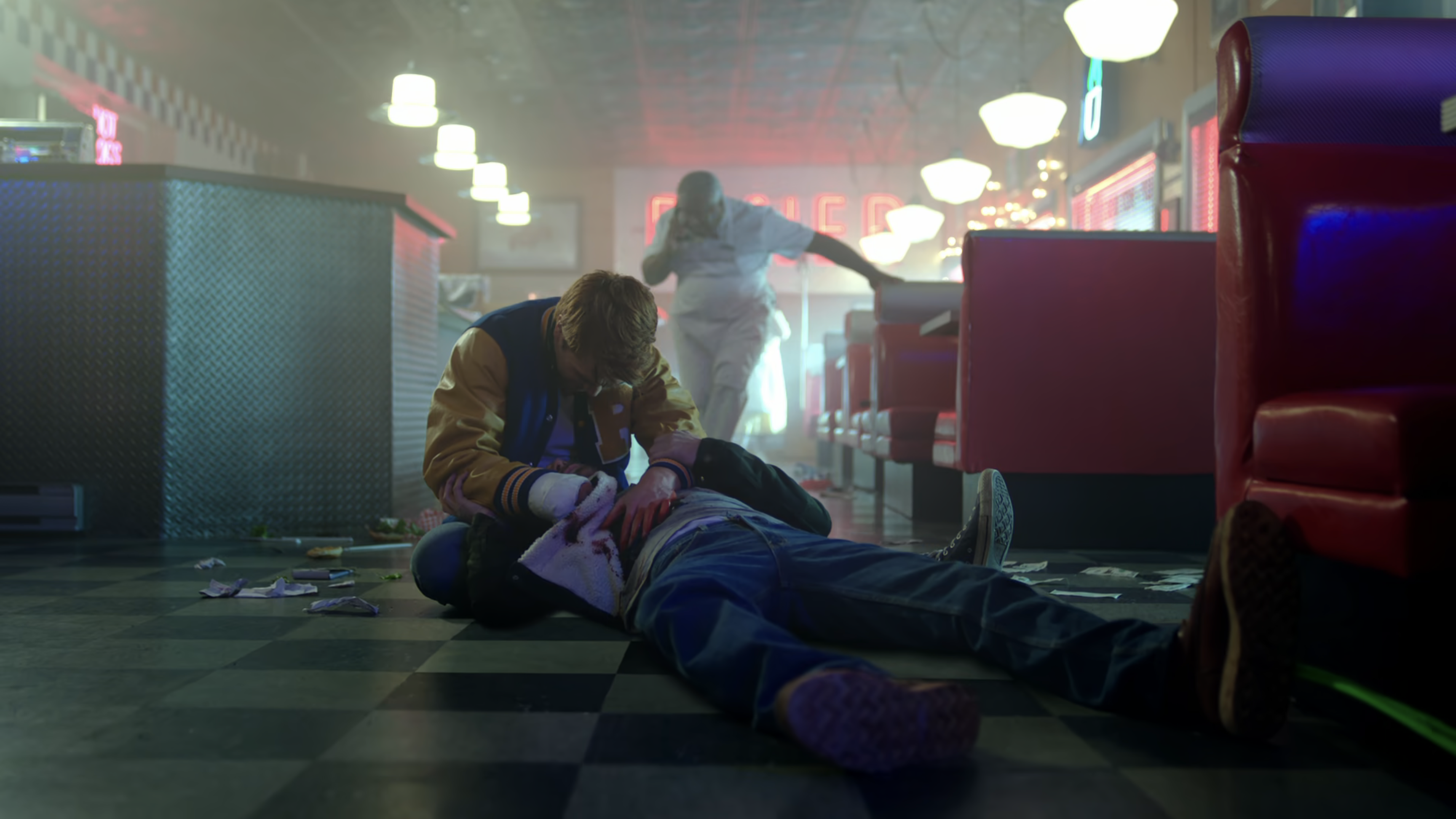 Archie craddles his dad in his arms after he's been shot.