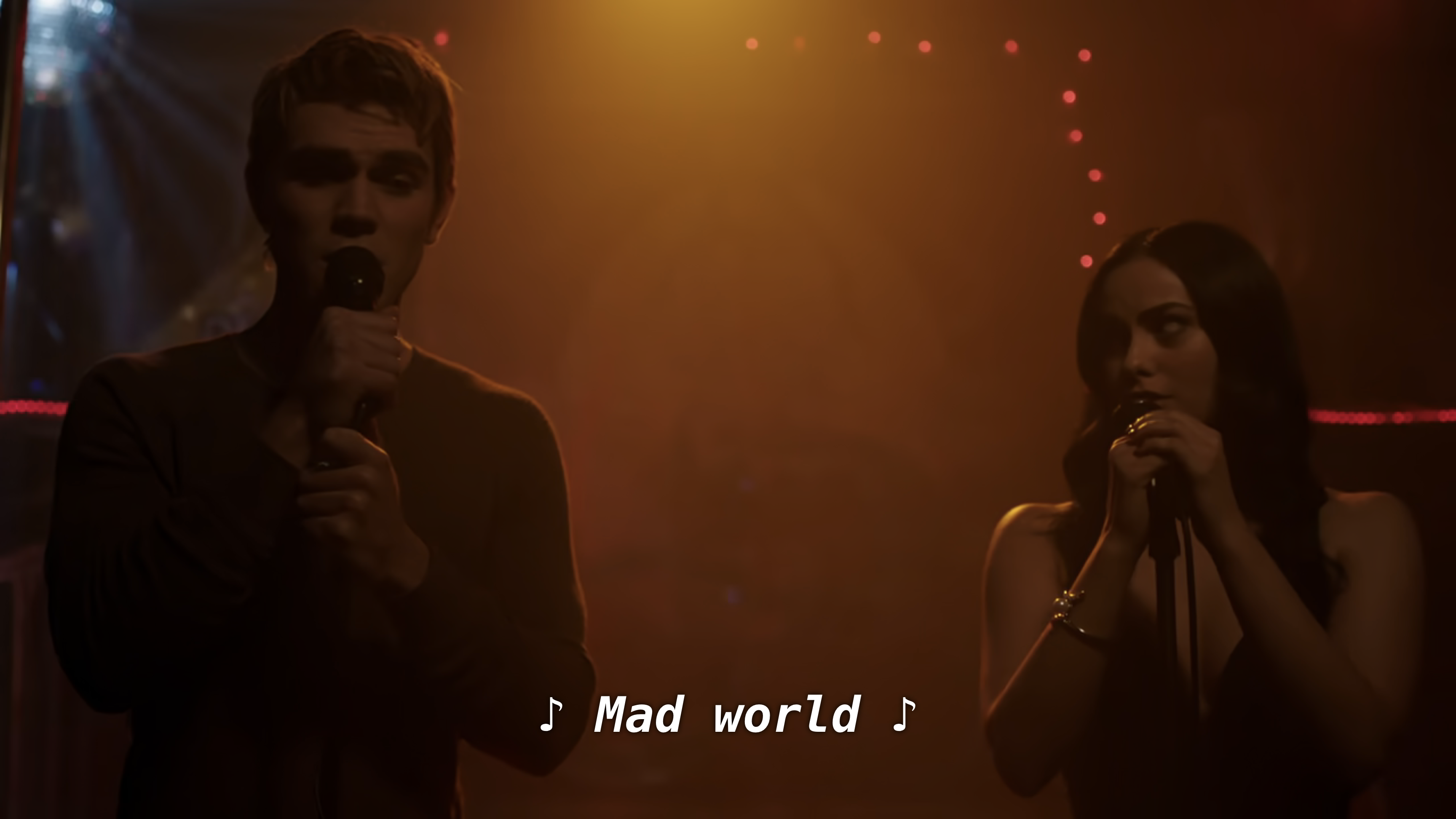 Archie and Veronica sing Mad World in orange lighting