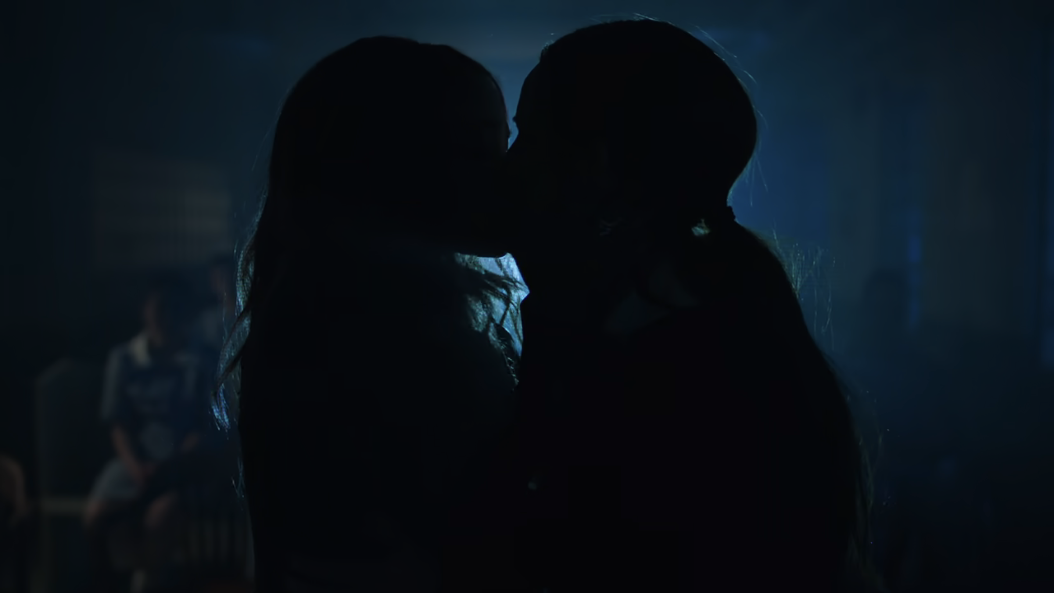 Toni and Cheryl kiss backlit