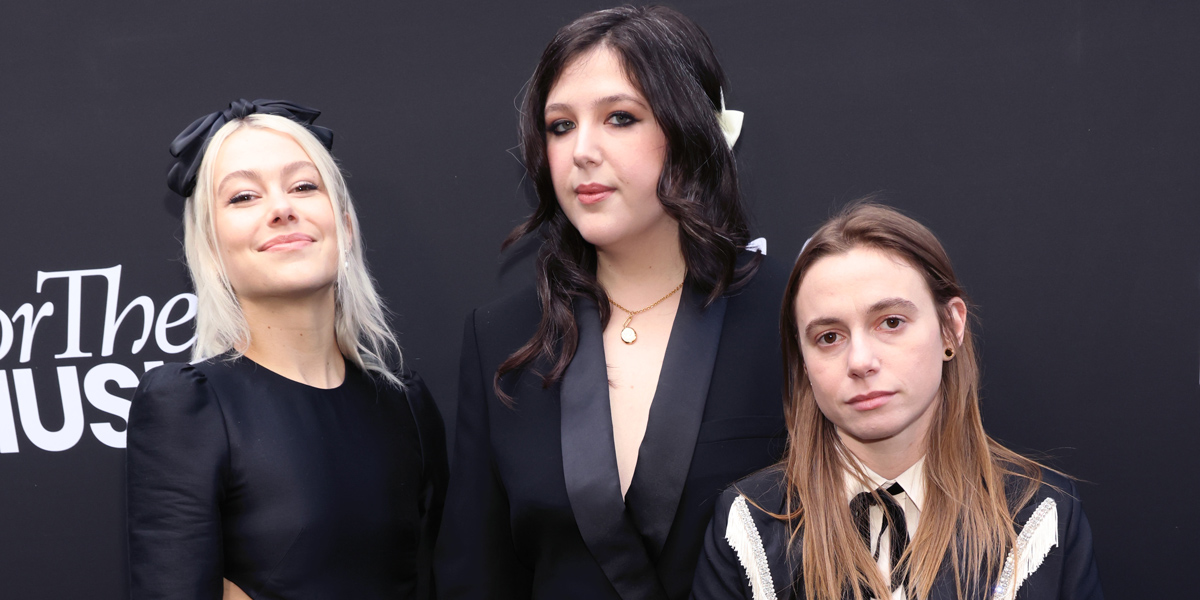 Boygenius, who have announced a hiatus, on the red carpet in matching black tuxes of various styles.
