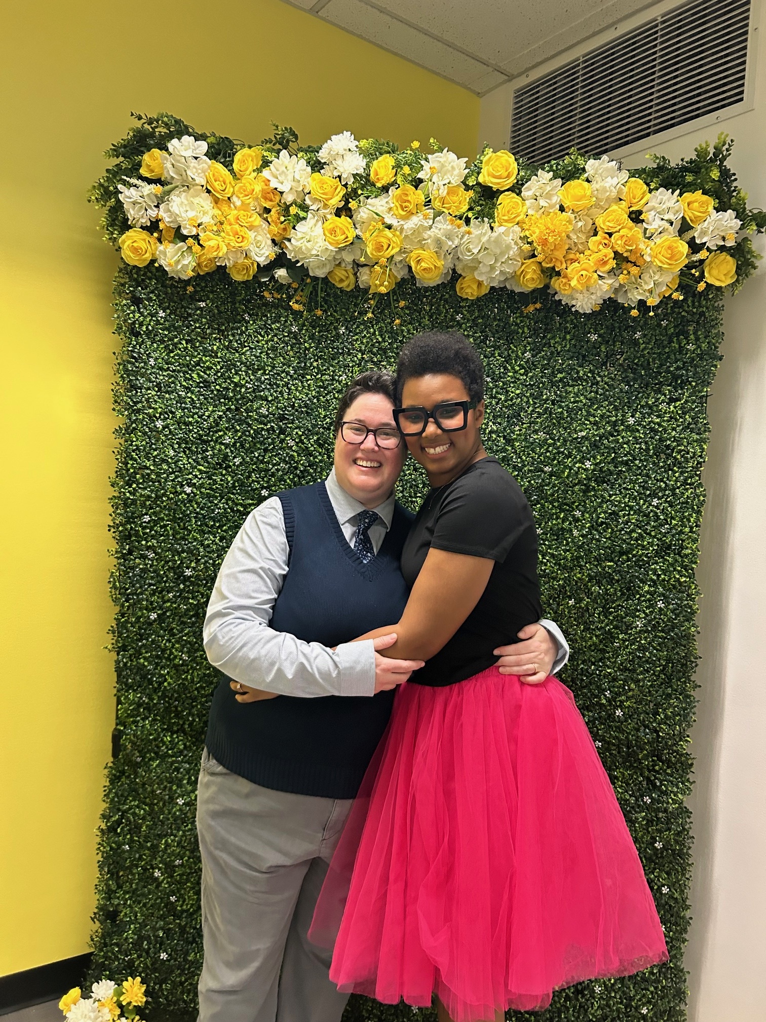 The author (a black woman with short hair) and her wife (a white butch with brown hair) pose on their wedding day.