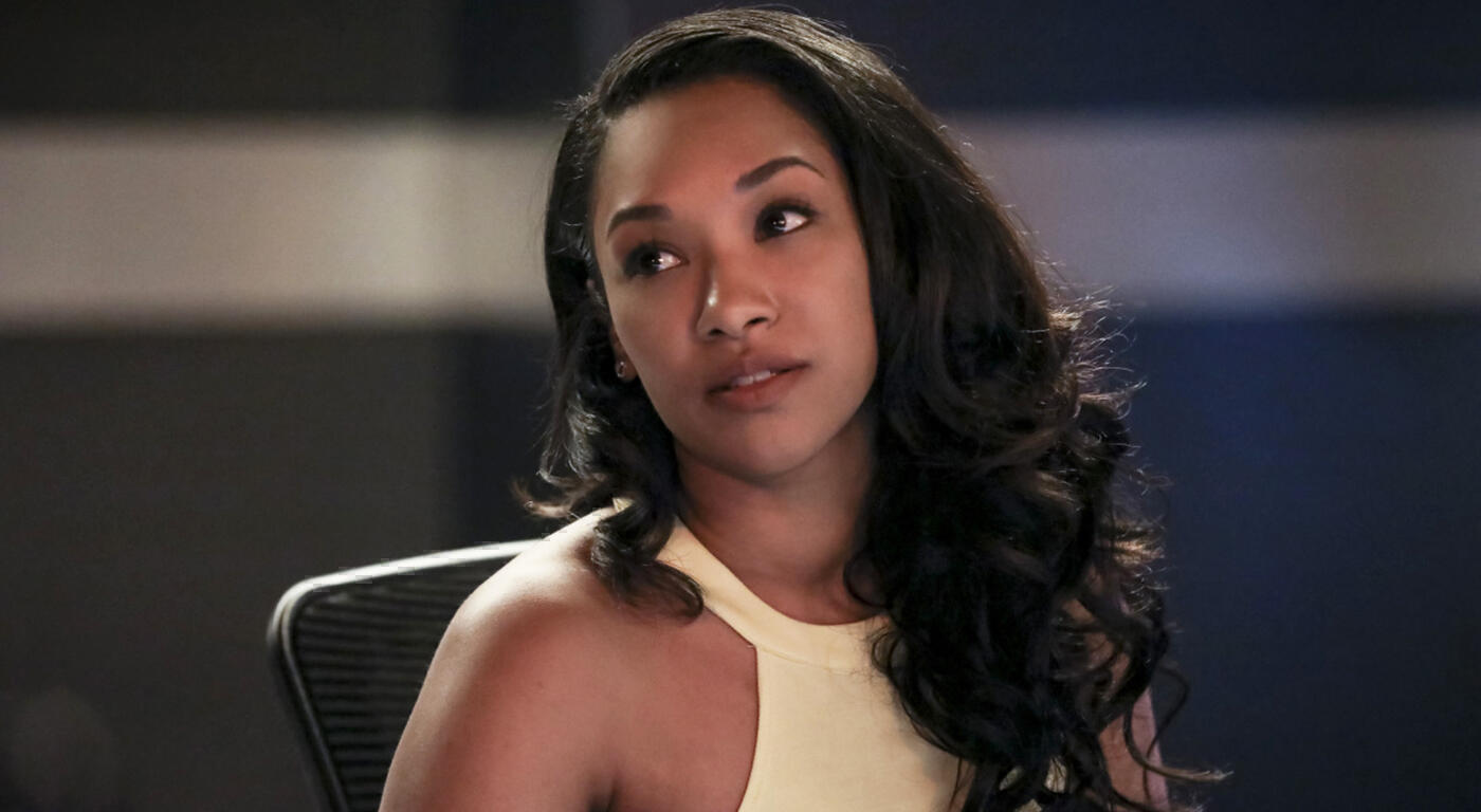 Candice Patton as Iris West in The Flash looks up while sitting at a table