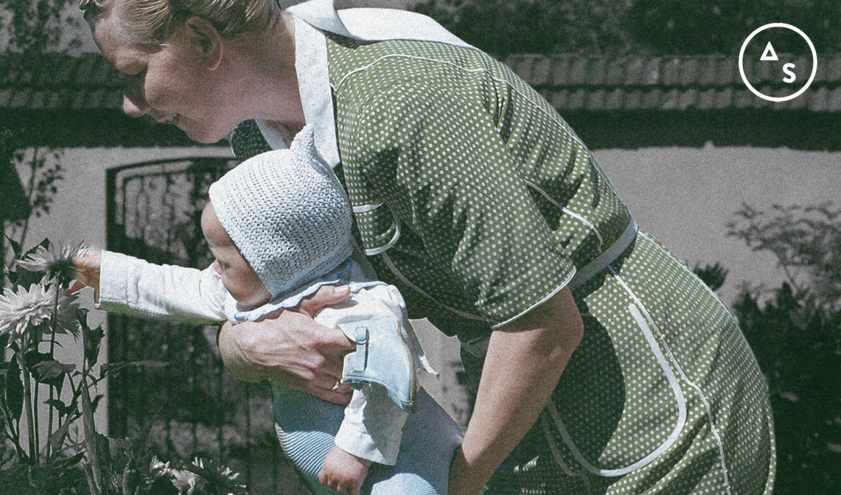 A grainy portion of a still from The Zone of Interest with Sandra Hüller holding a baby.