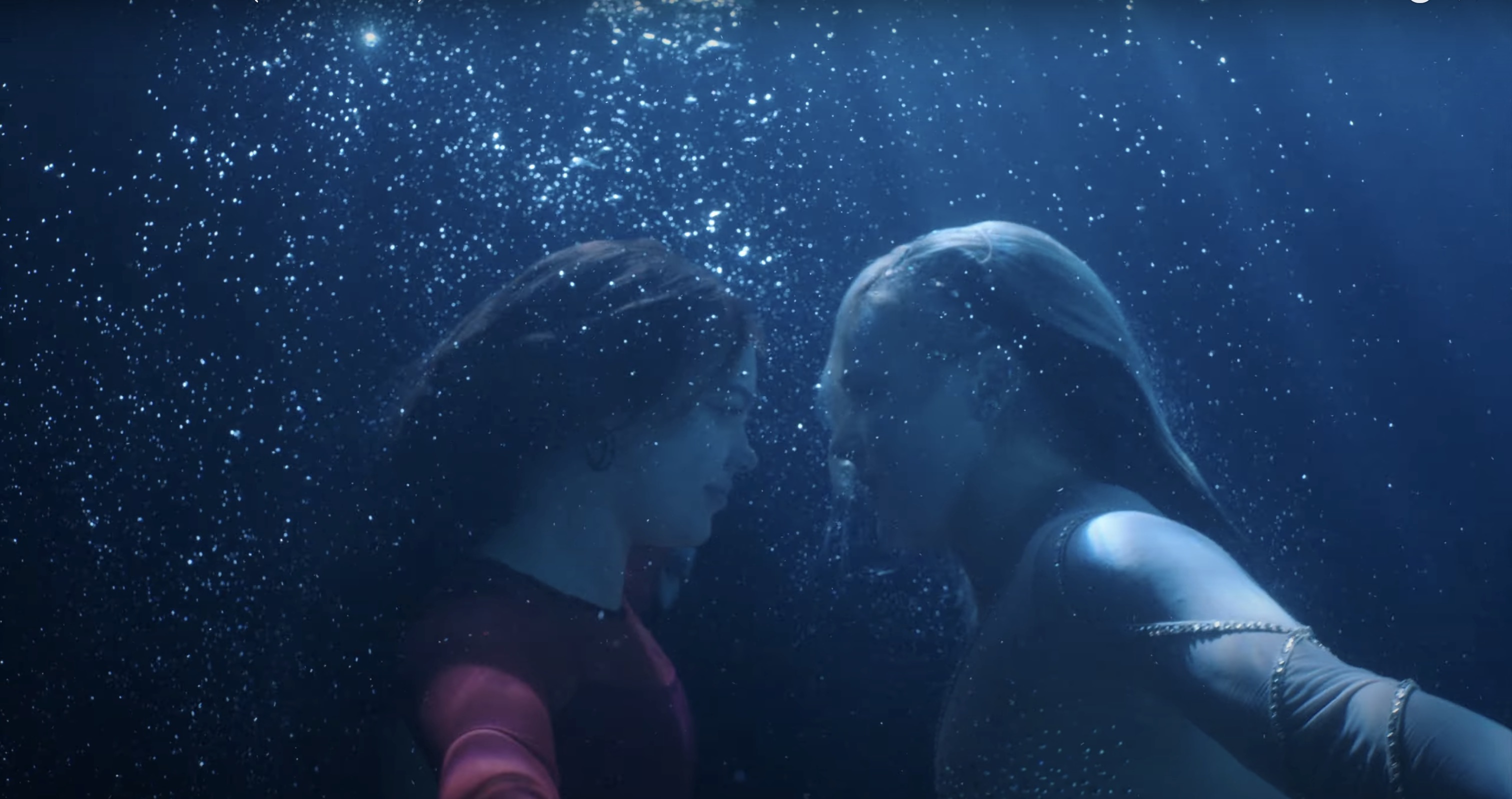 JoJo and a girl underwater looking at each other with bubbles