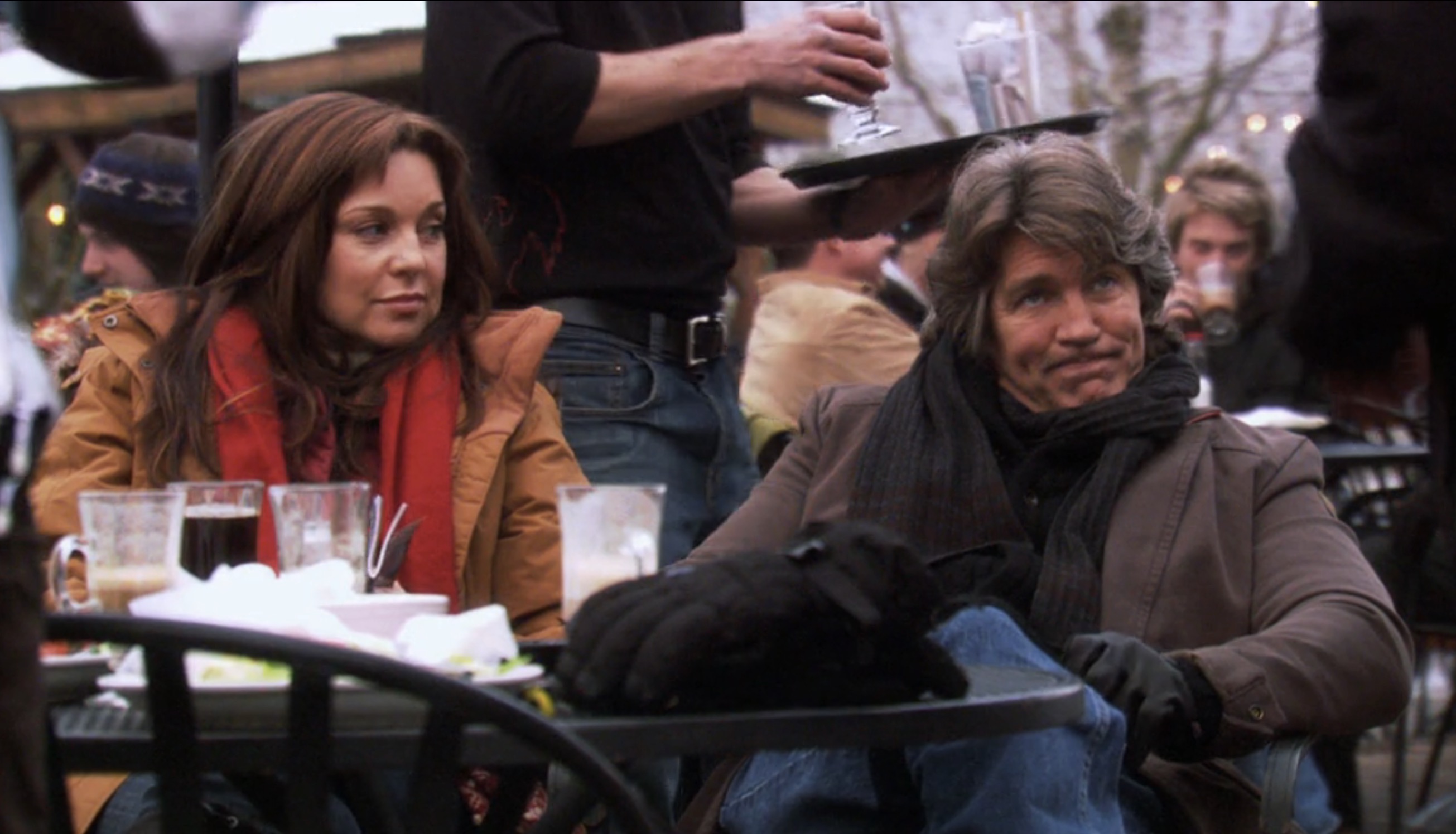 gabe and his wife sitting outside at the ski resort