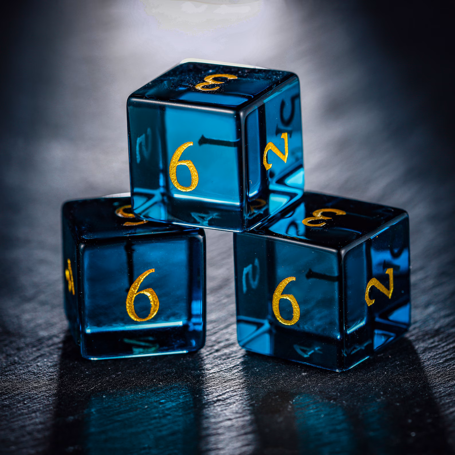 dark blue dice with gold lettering