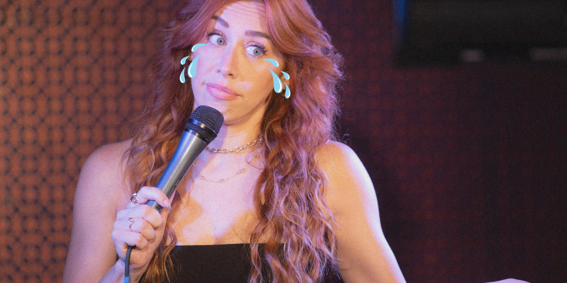 a woman with a mic and tears coming out of her eyes