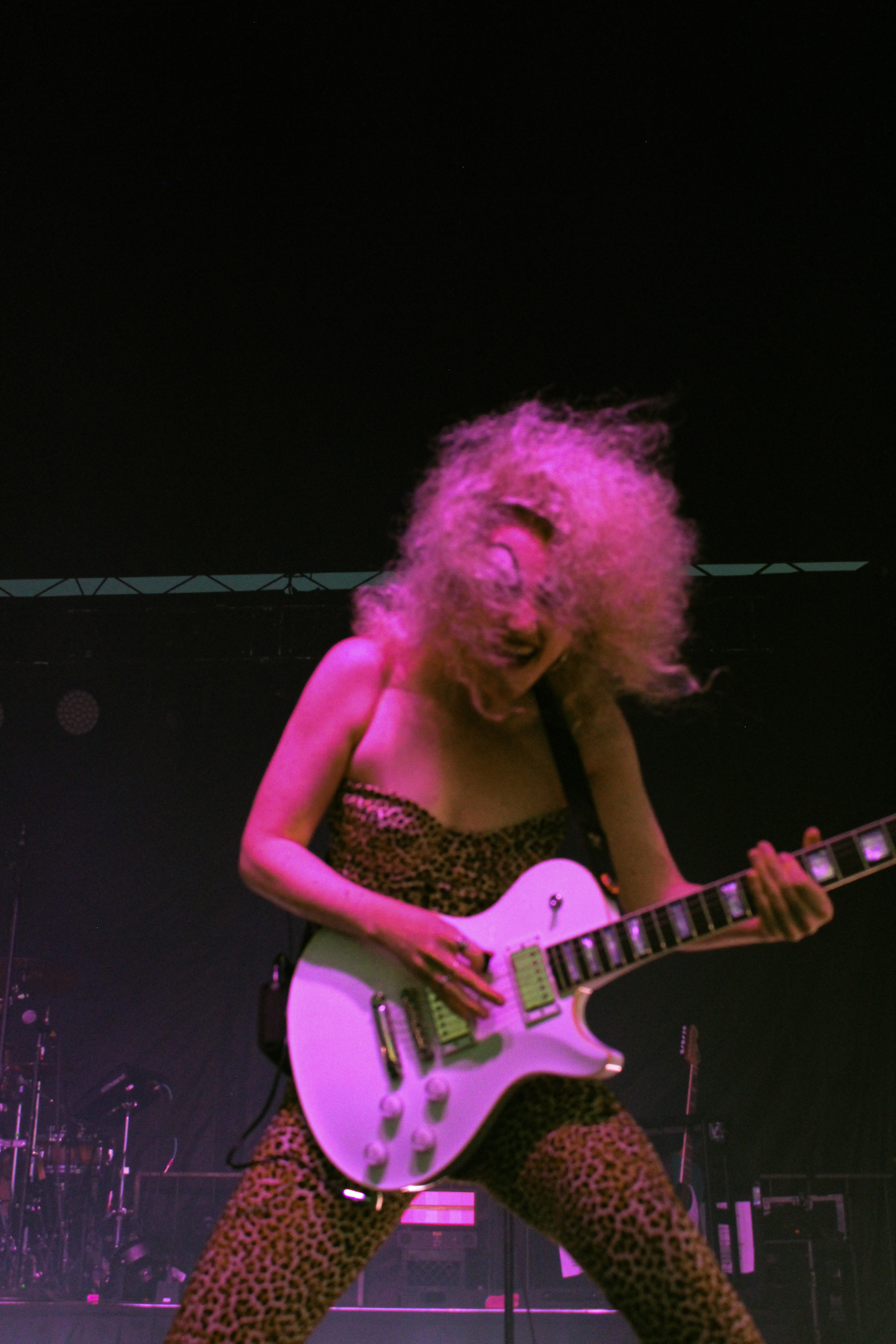 Chappel Roan with a guitar and a leopard onepiece
