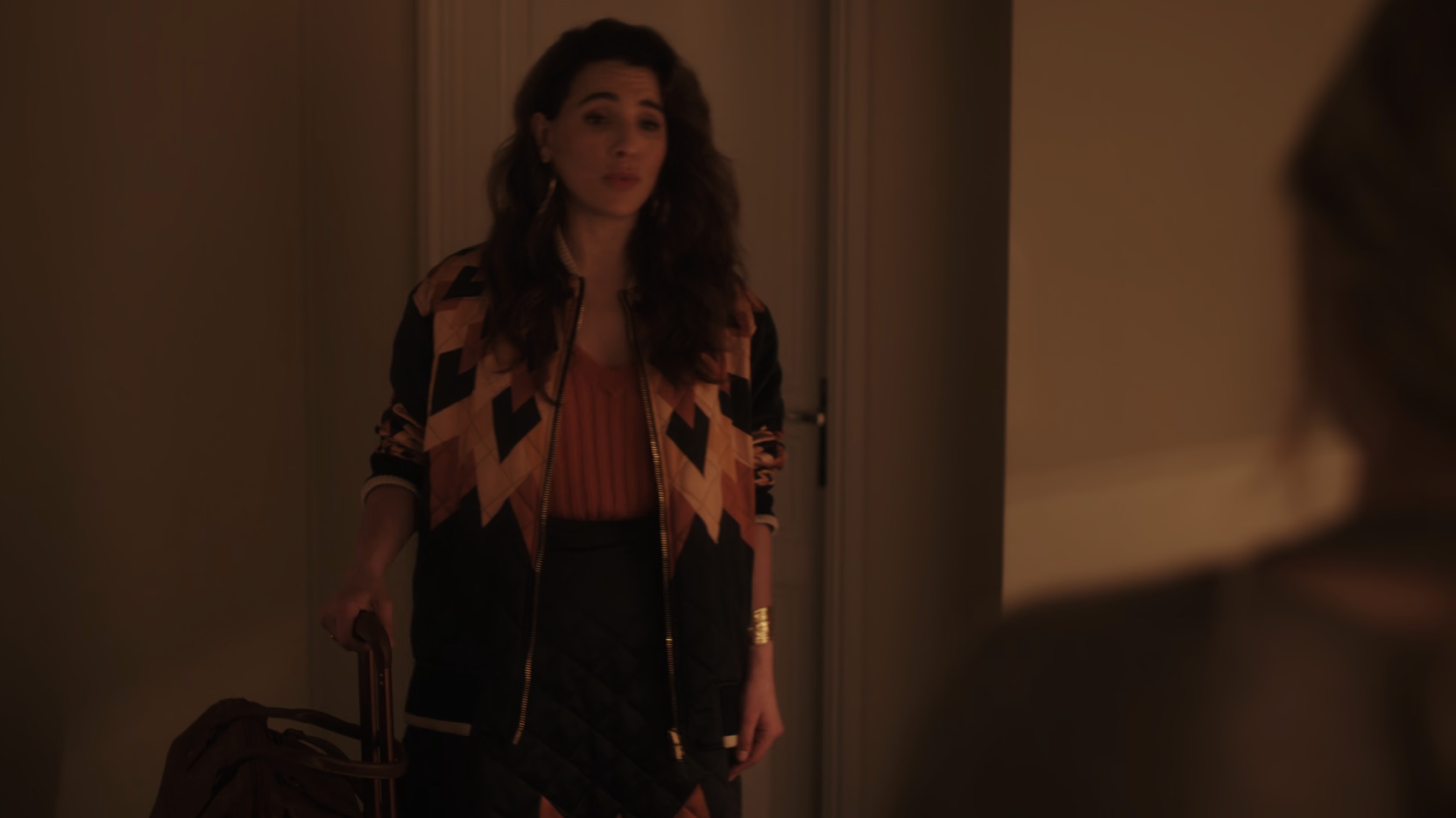 Sofia standing at the door with her suitcase