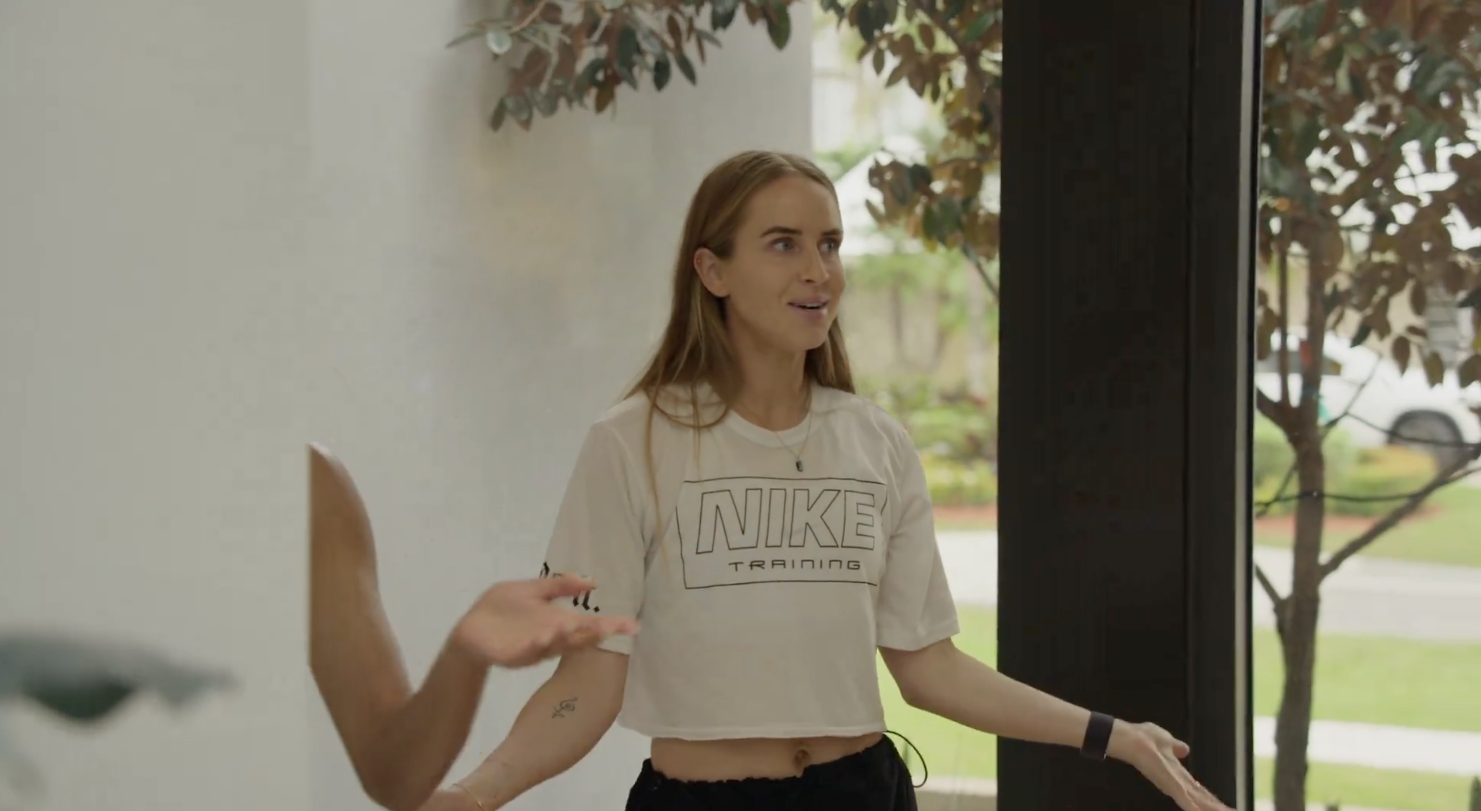 Nikki arrives at the house in her nike shrit