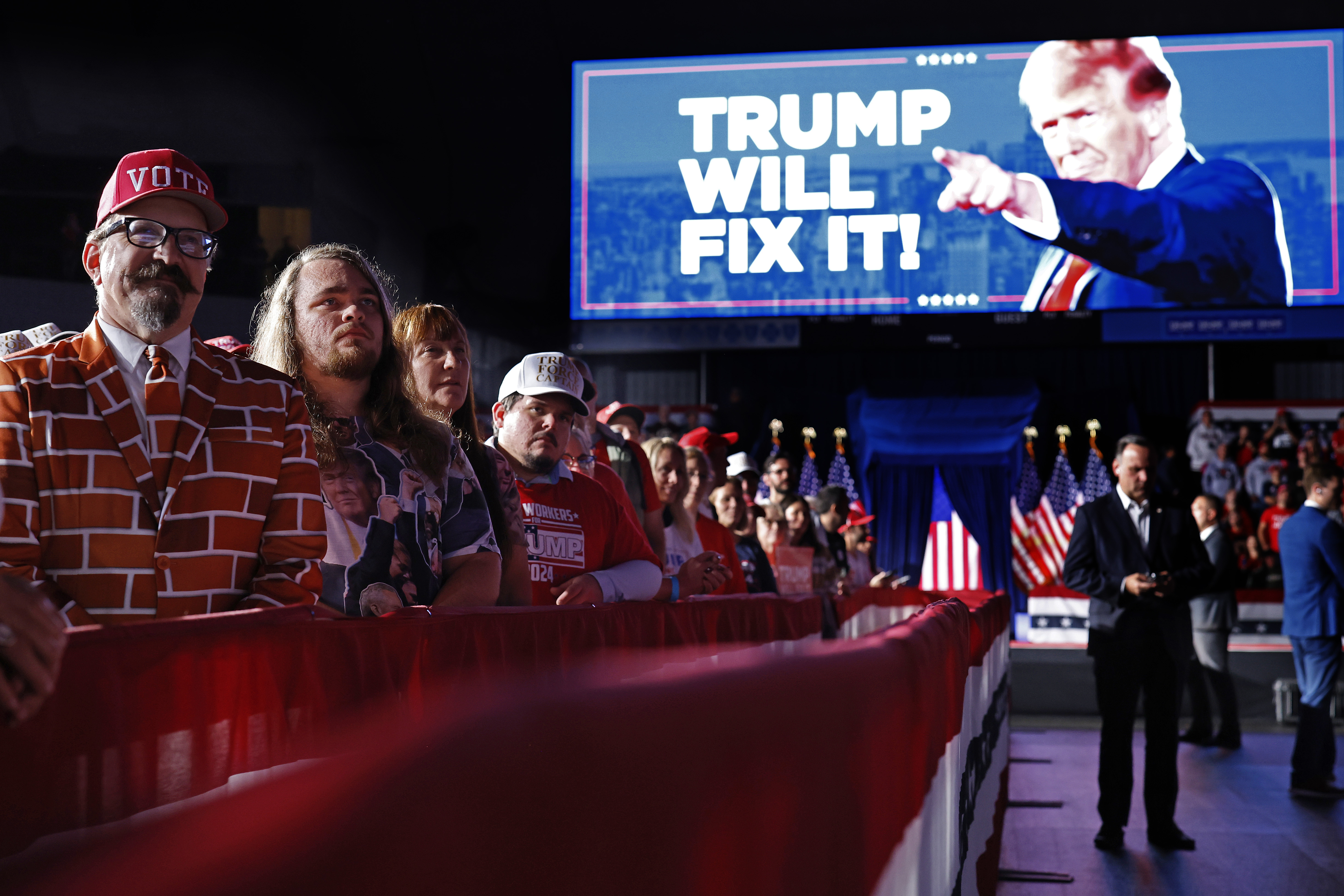 GRAND RAPIDS, MICHIGAN - NOVEMBER 05: Supporters listen to Republican presidential nominee, former President Donald Trump during his last campaign rally at Van Andel Arena on November 05, 2024 in Grand Rapids, Michigan. Trump campaigned for re-election in the battleground states of North Carolina and Pennsylvania before arriving for his last rally minutes after midnight in Michigan. (Photo by Chip Somodevilla/Getty Images)