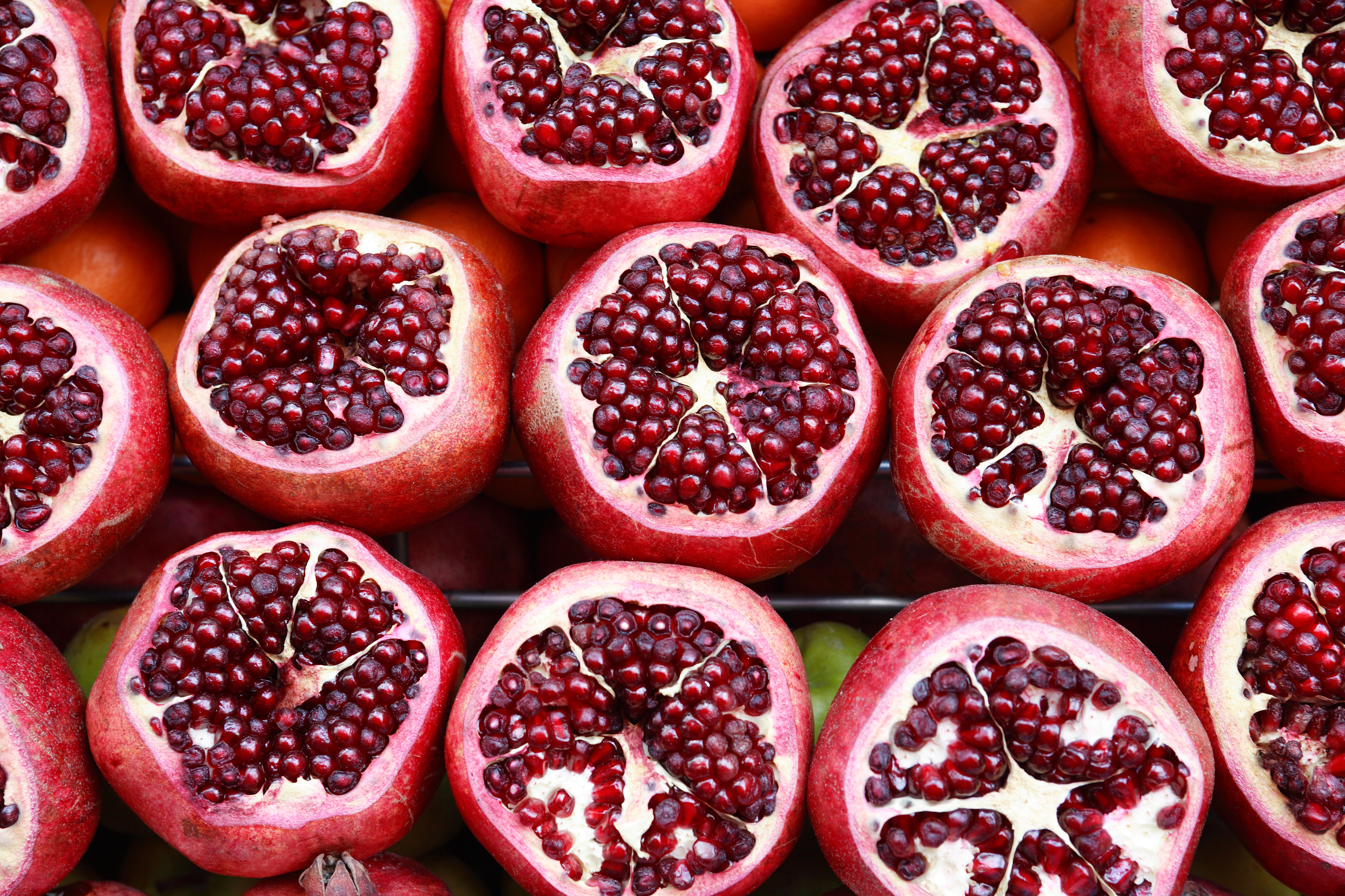 Lot of sliced pomegranates as background