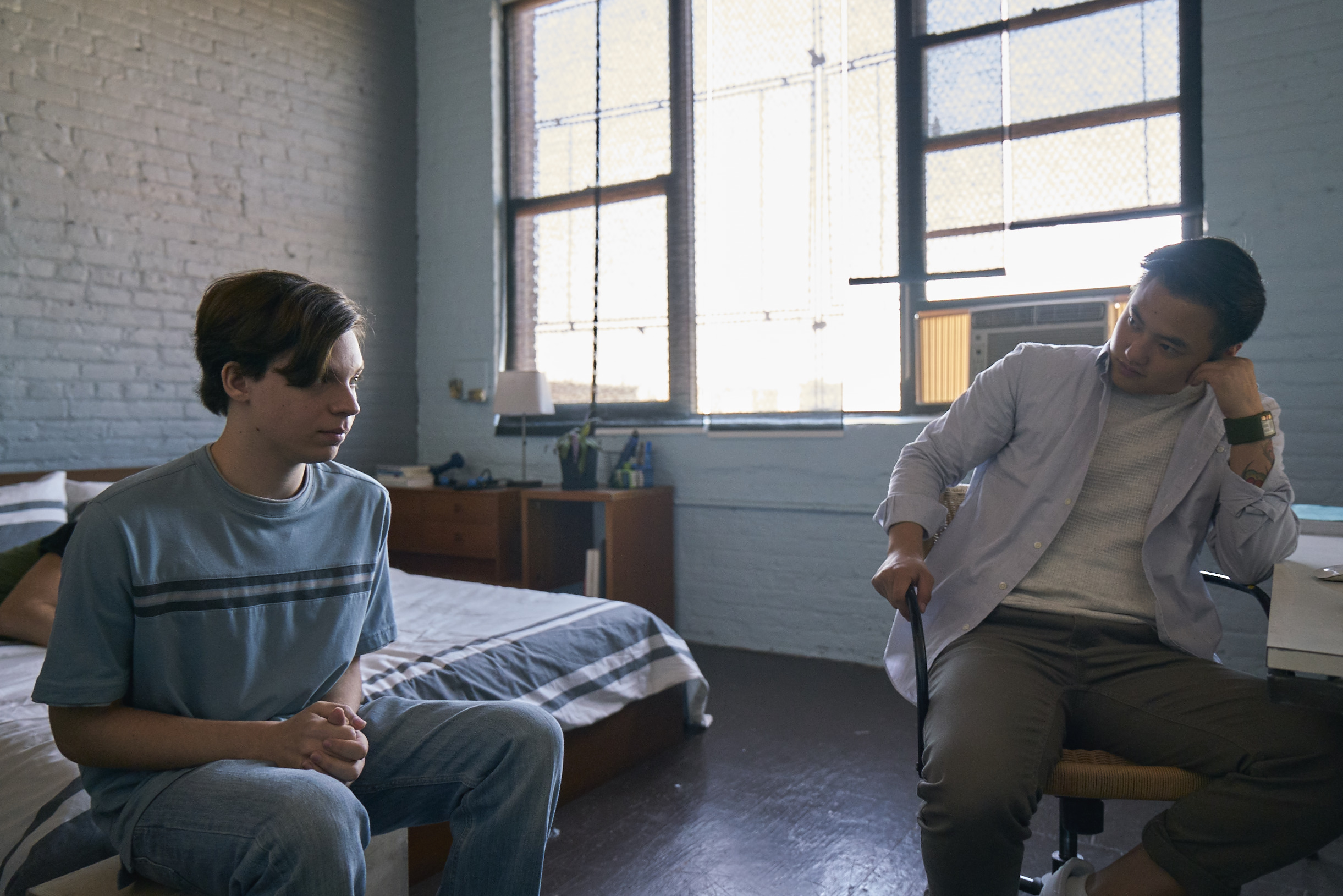 Nicholas Alexander sits awkwardly talking to Leo Sheng in Adam