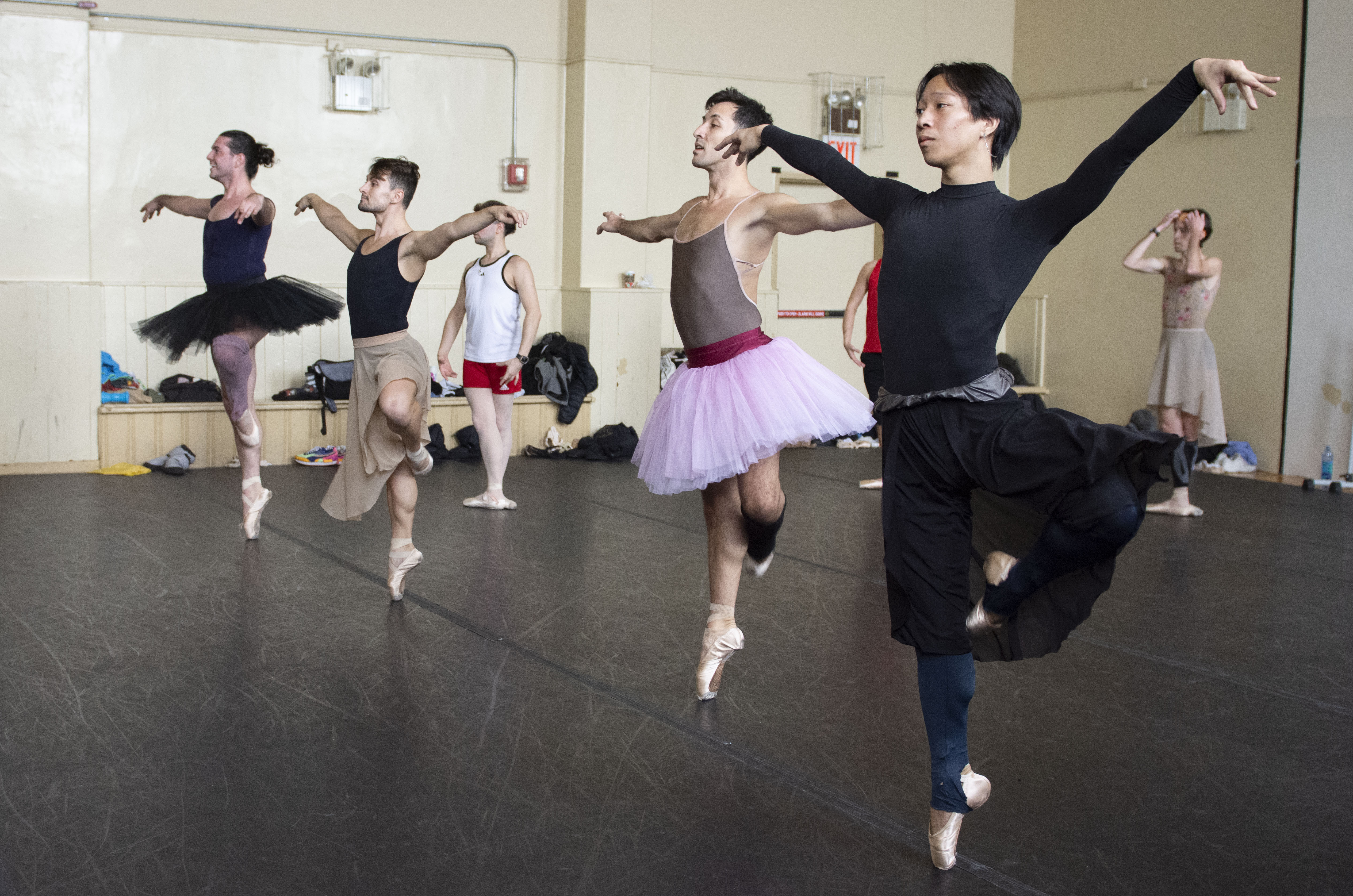 A group of dancers from the Trocks dance in rehearsal.