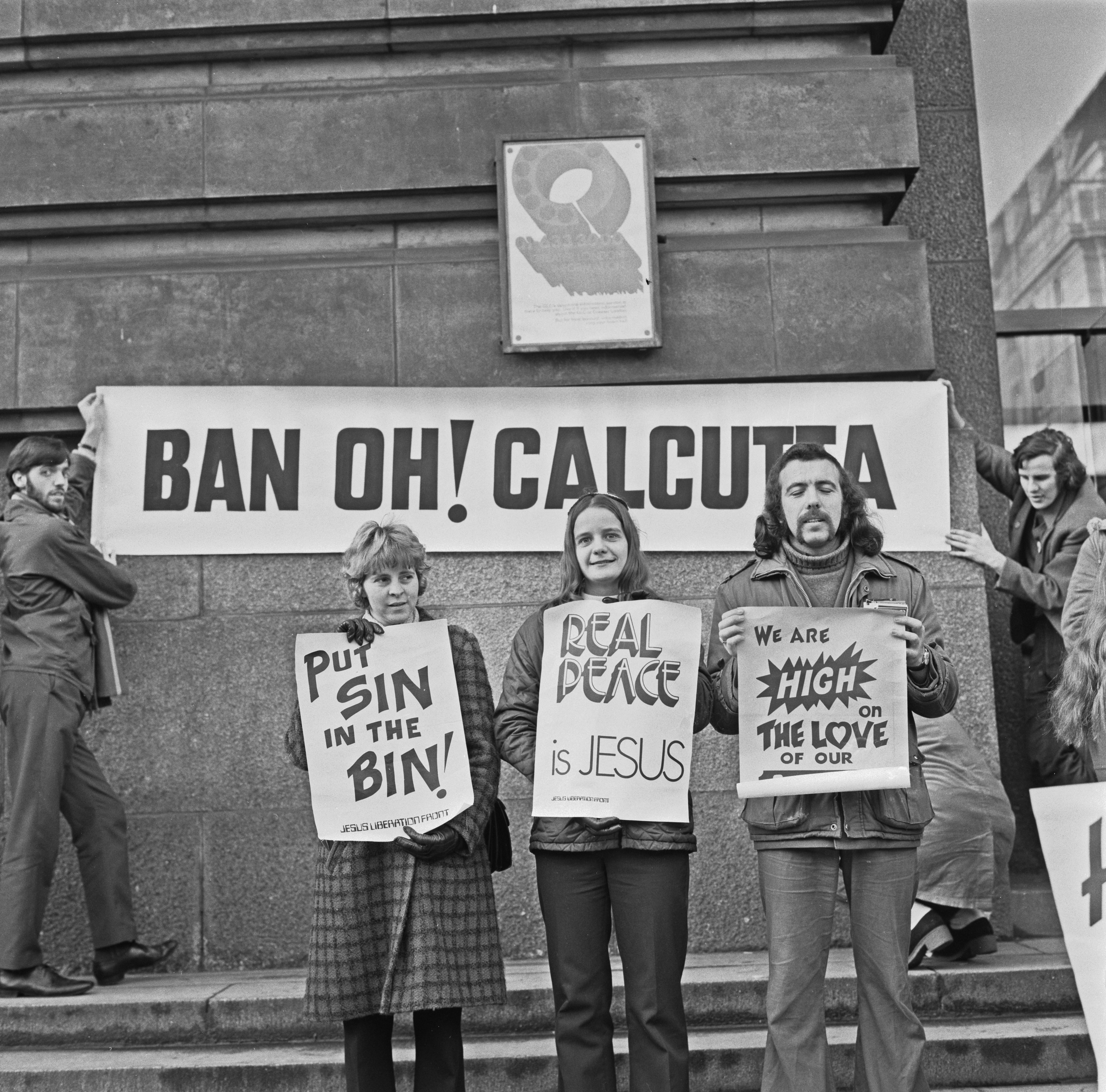 A Christian group protest against theatrical revue Oh! Calcutta!, in an attempt to have it banned from the stage in London, UK, 1st January 1973. Pictured are June Keeble, Mirja Kivimaki and Wilson Murdoch, holding signs reading 'Put Sin in the Bin!', and 'Real Peace is Jesus' etc. (