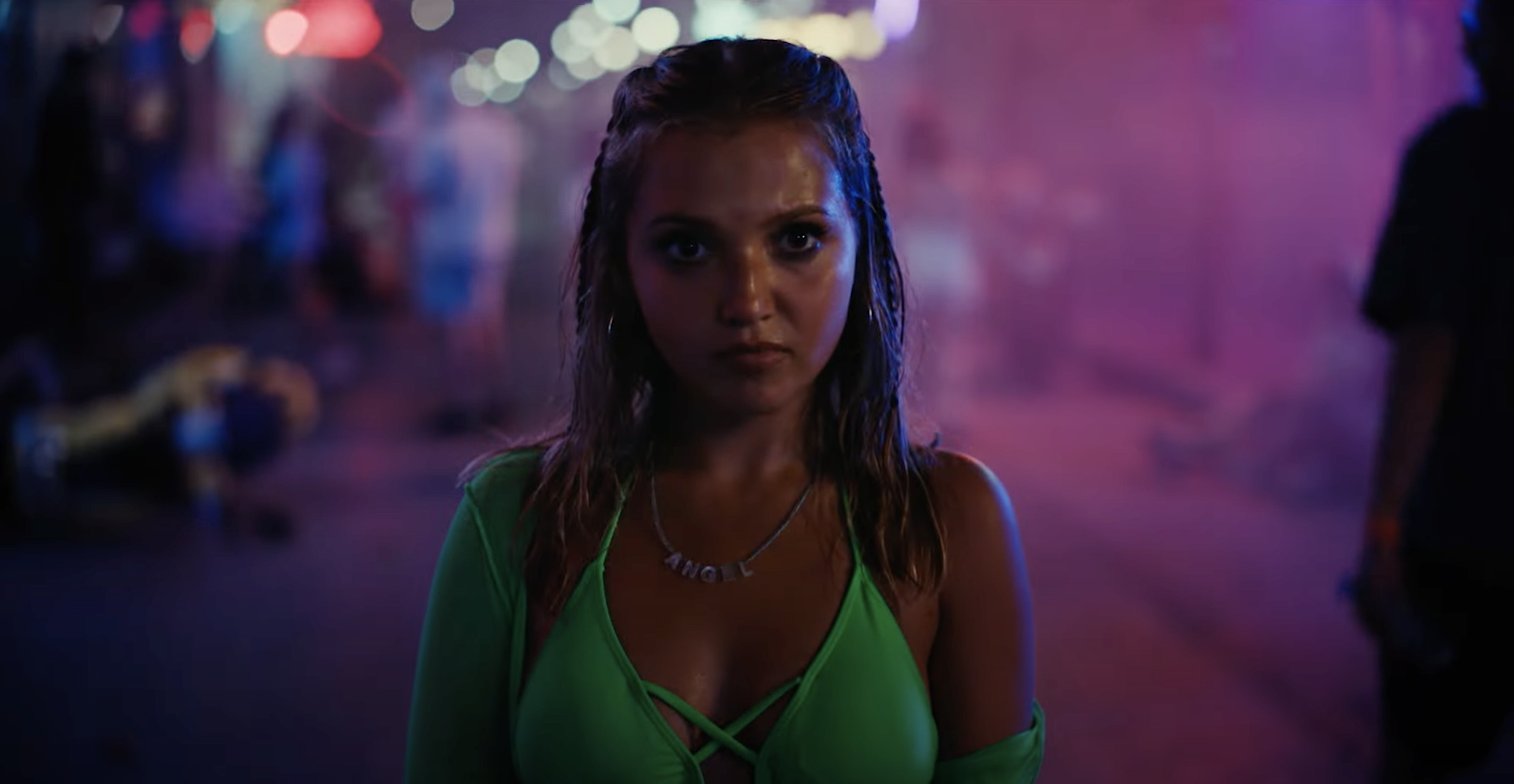 Mia McKenna-Bruce in How to Have Sex in a green bikini top at night.