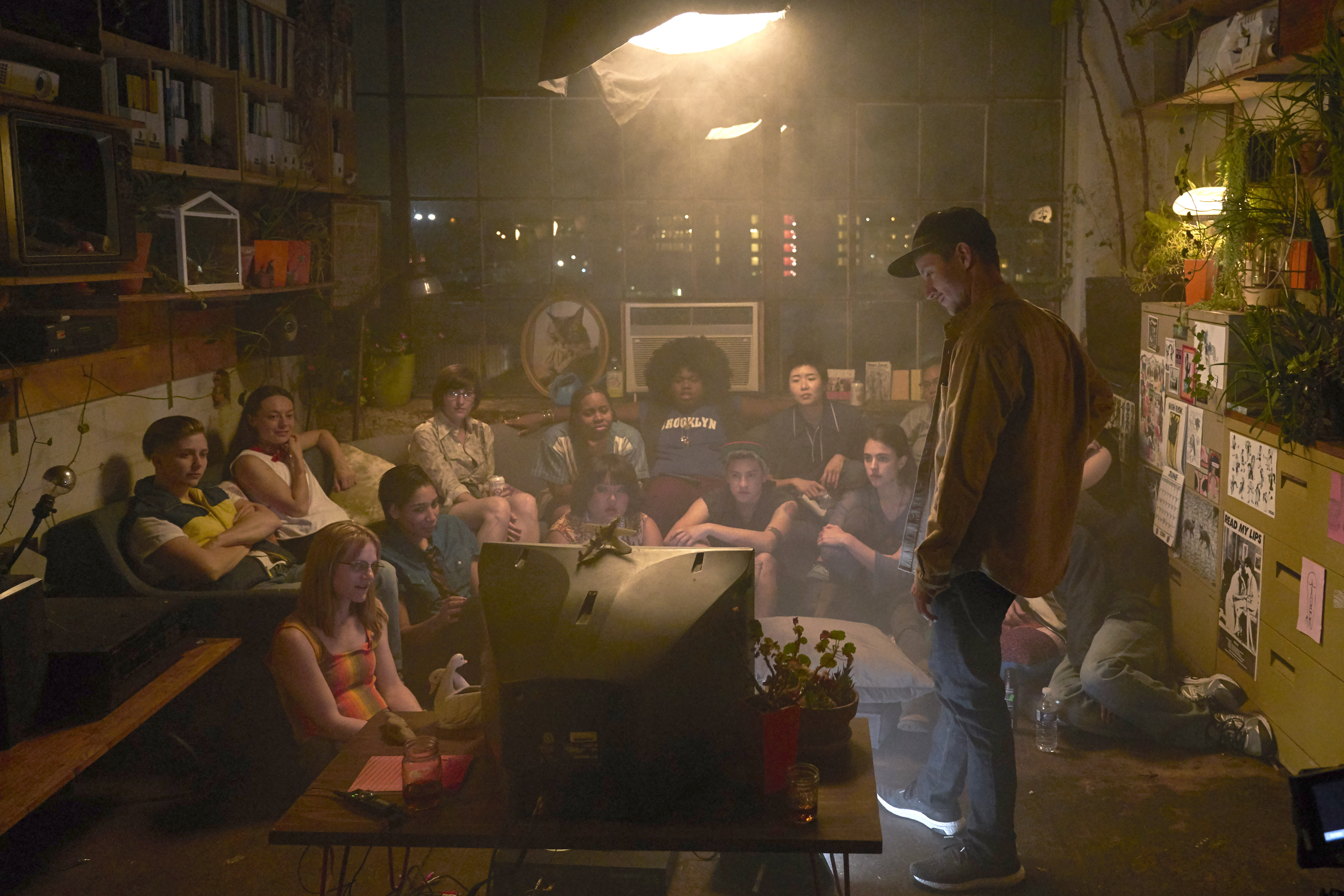 In a room full of queer and trans actors, director Rhys Ernst looks at a 2006 era tv with the cast.