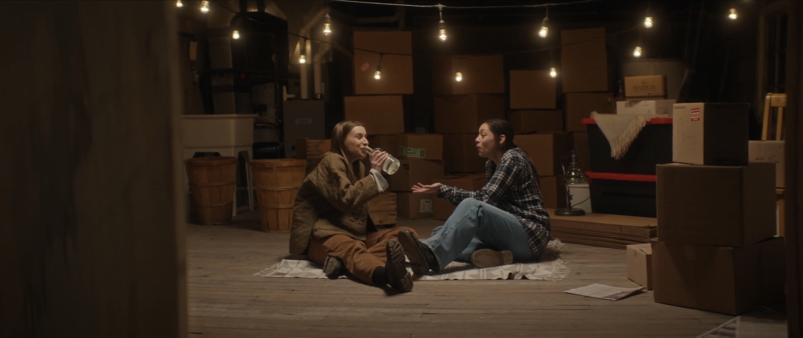 sitting on the floor in the basement together drinking
