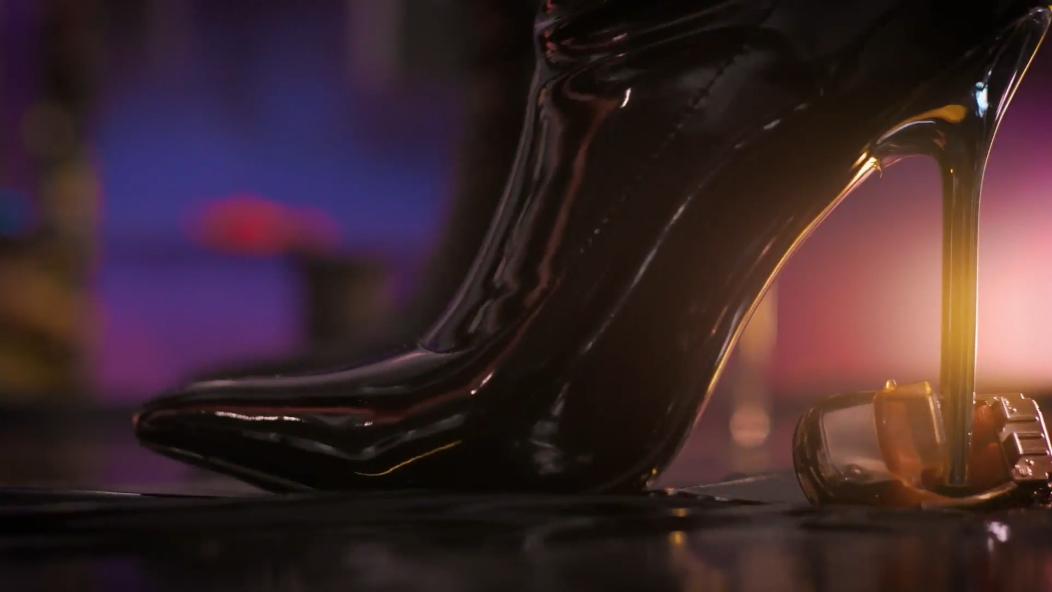 A close up of a heeled boot stepping on a toy car in Thigh Rise