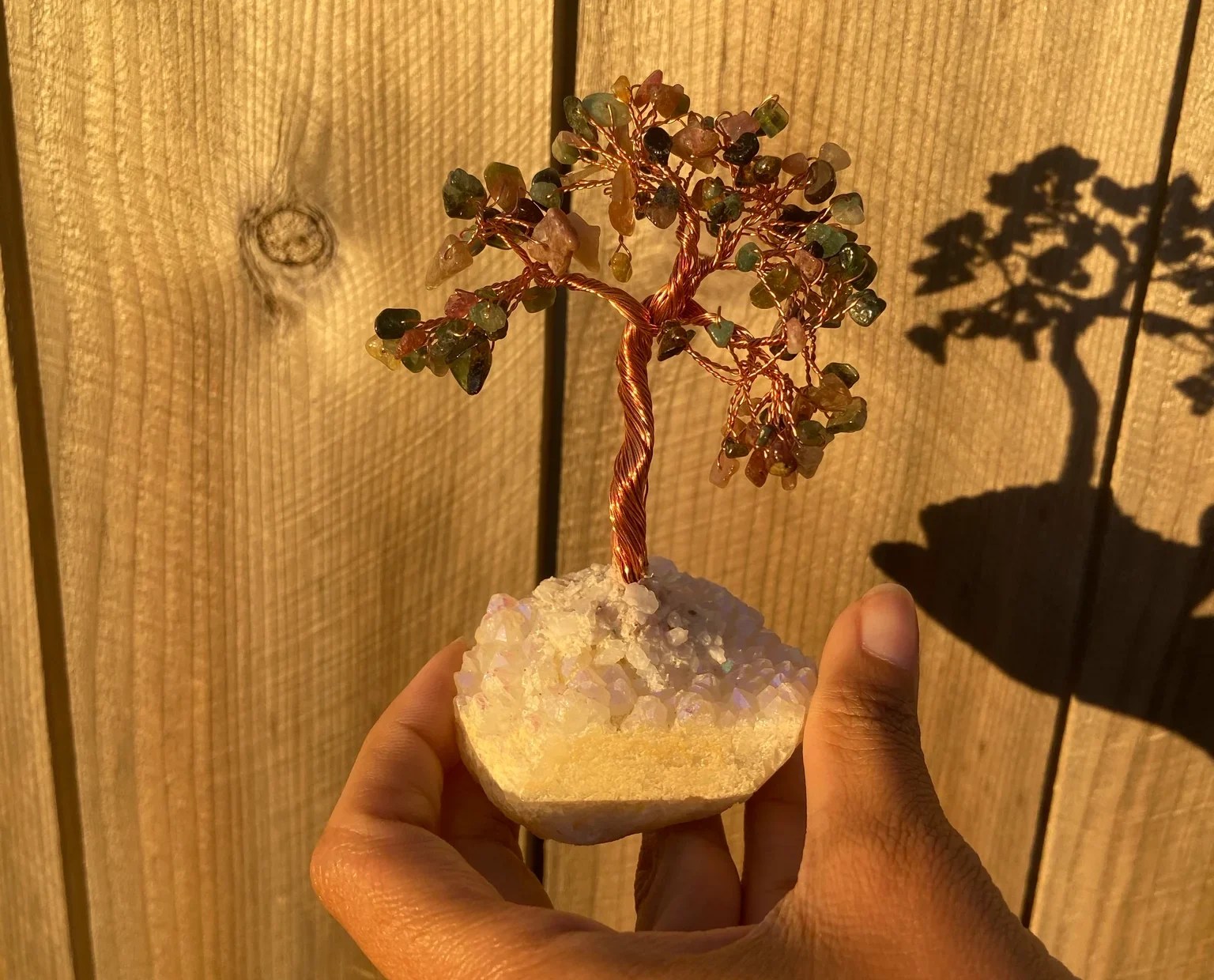 bonsai tree with Angel Aura Quartz base it heightens the energy of the crystals featured on the bonsai tree.