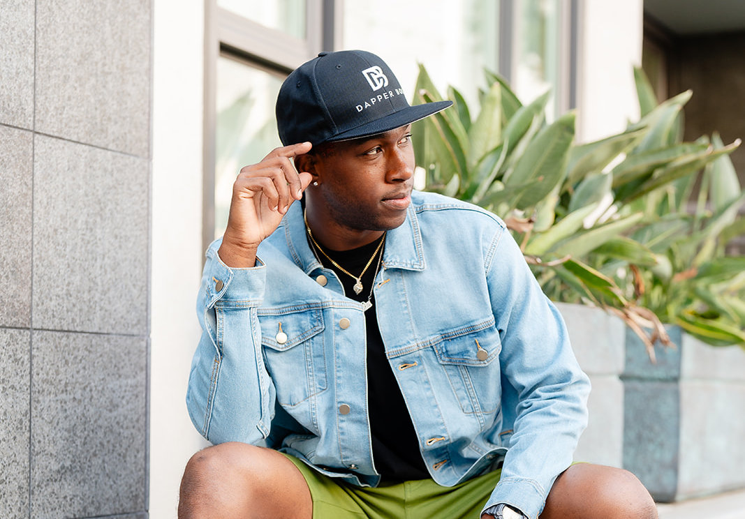 dapper boi model with denim shirt and dark hat