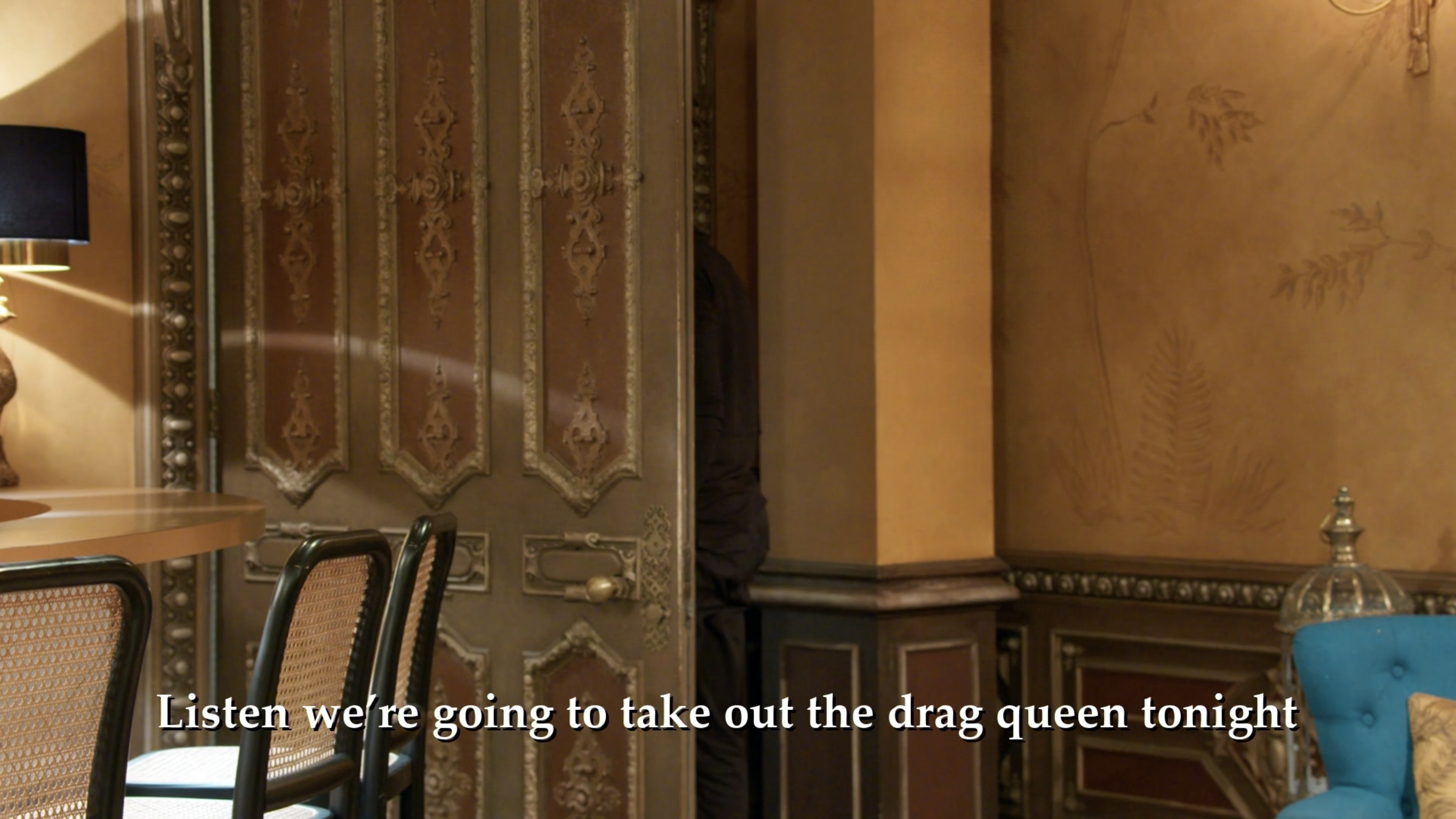 An image of an empty room with text on the bottom that reads: We're going to take out the drag queen tonight.