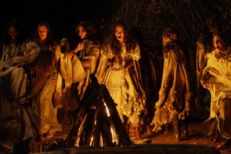 Lottie and the others screaming around a fire