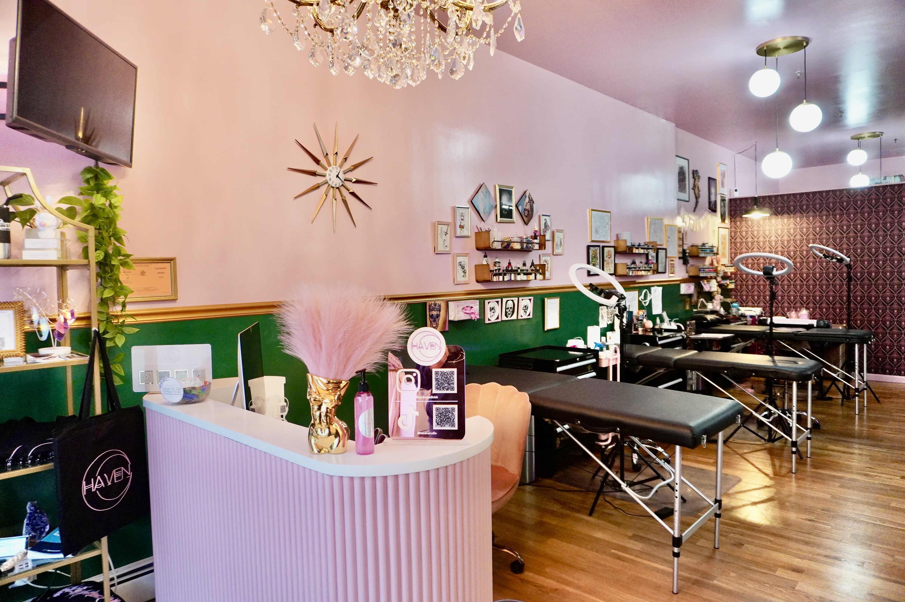 Four tattoo tables lined up at Haven, a parlor with a pink feminine aesthetic.