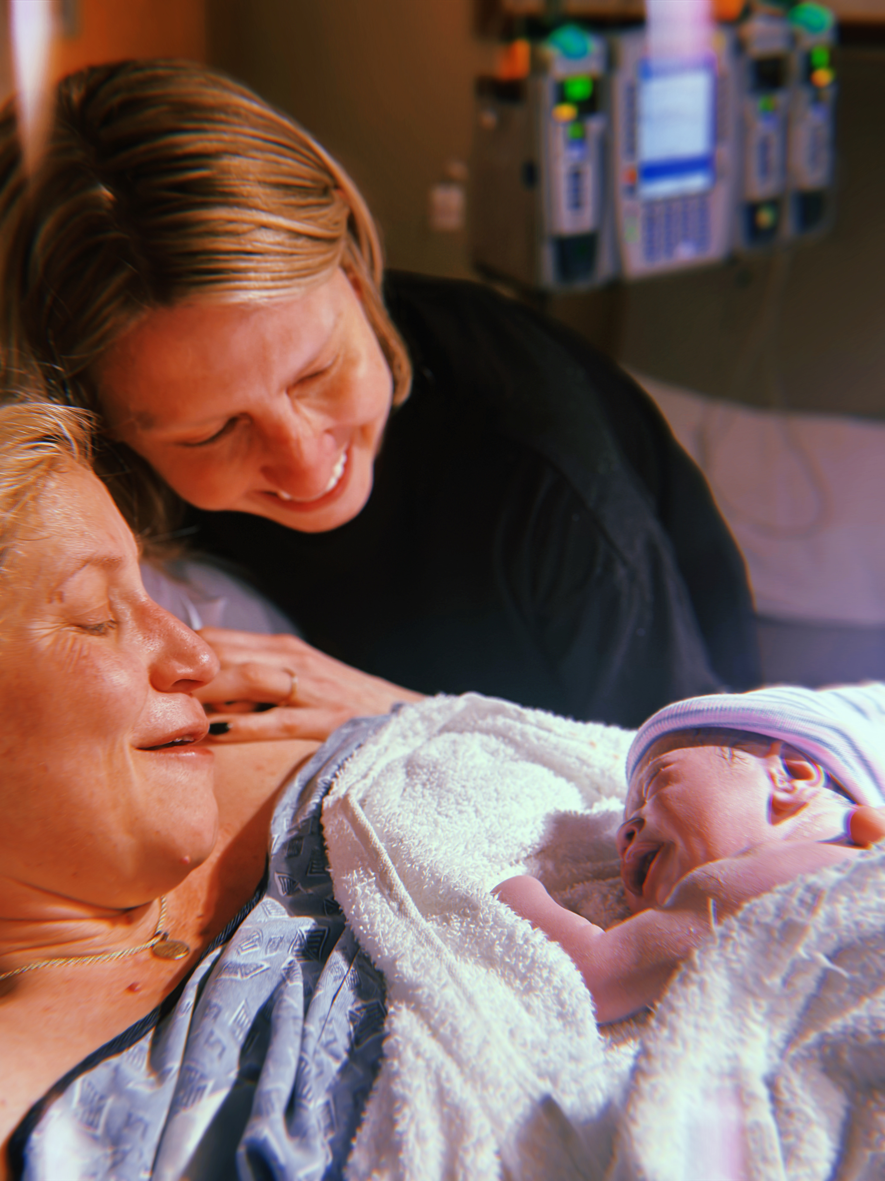 gretchen and riese looking at their baby
