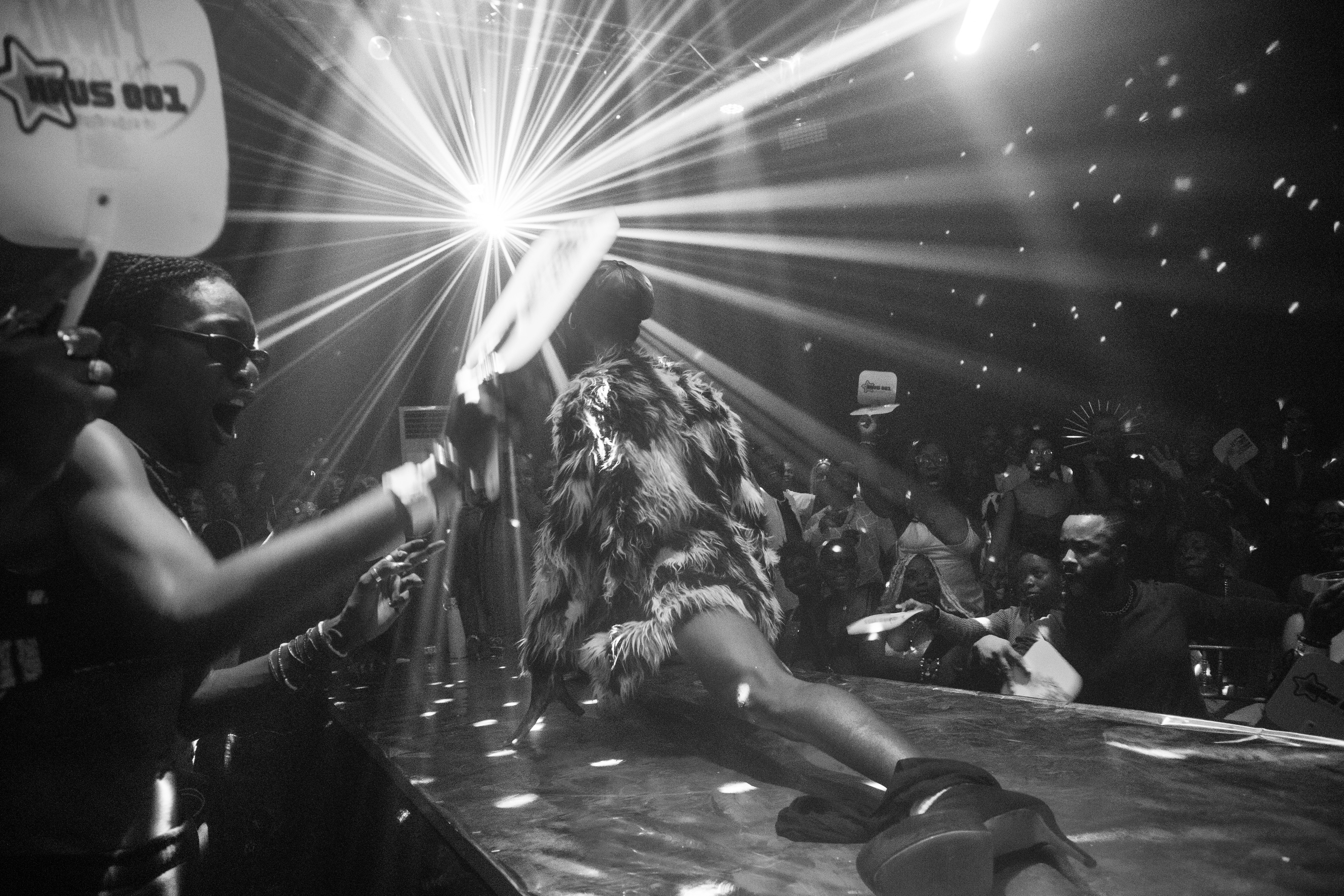 Heavenly Bodies a ballroom performer in the splits wearing a fur coat