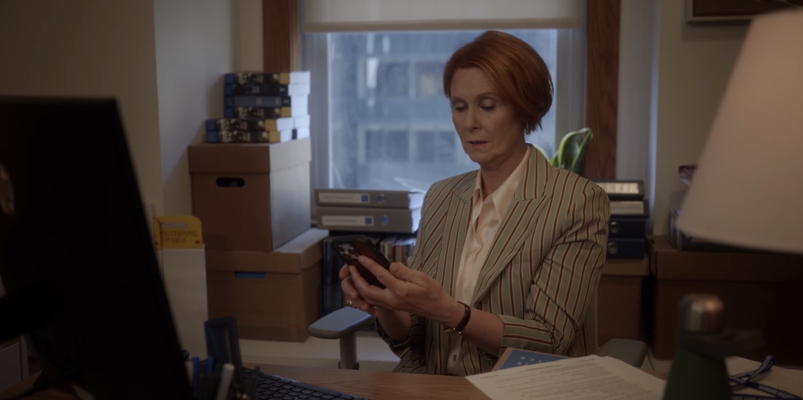 Miranda at her desk with her phoen