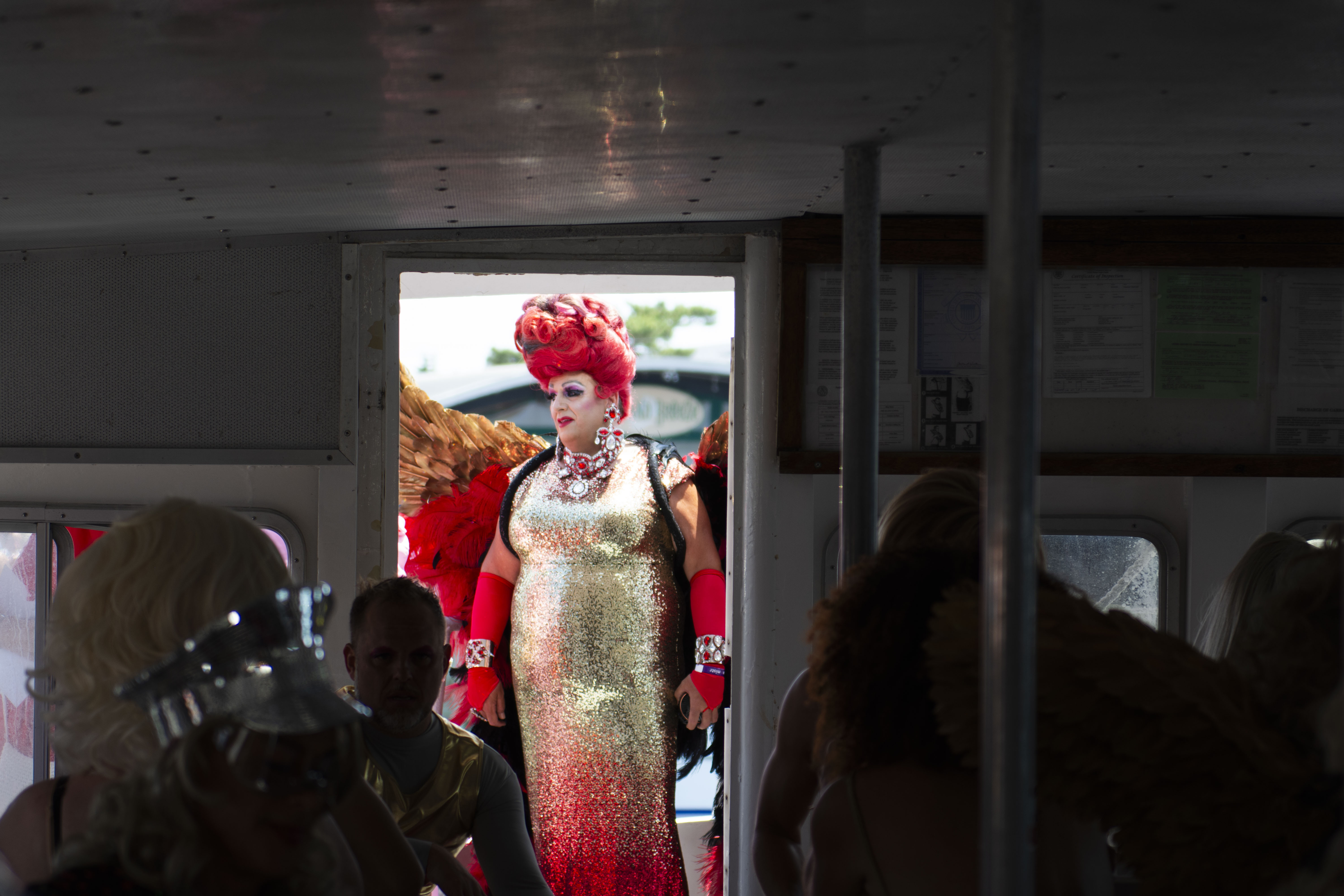 a drag queen boards the ferry for the 50th invasion of the pines