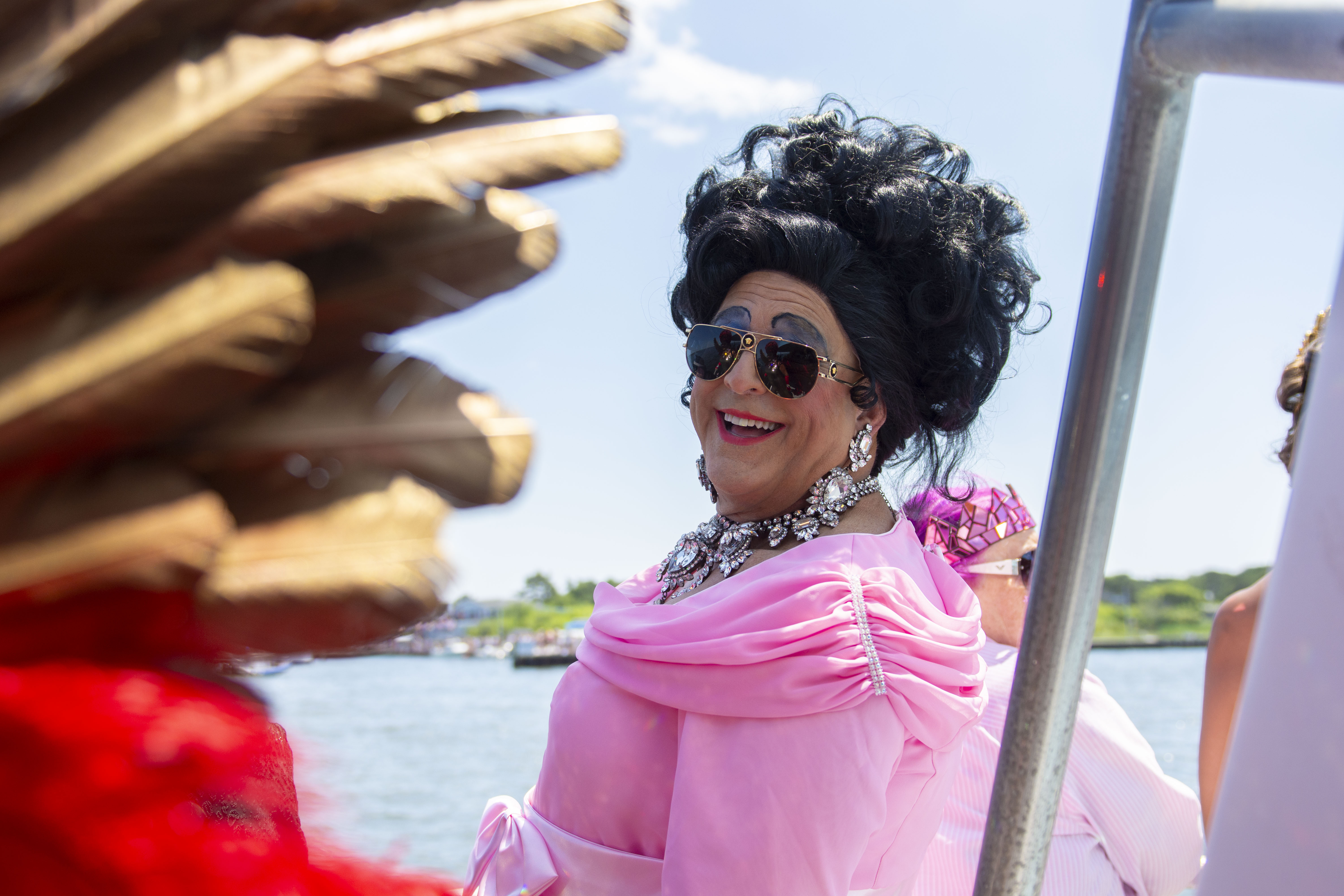 a drag queen onboard the ferry for the 50th invasion of the pines