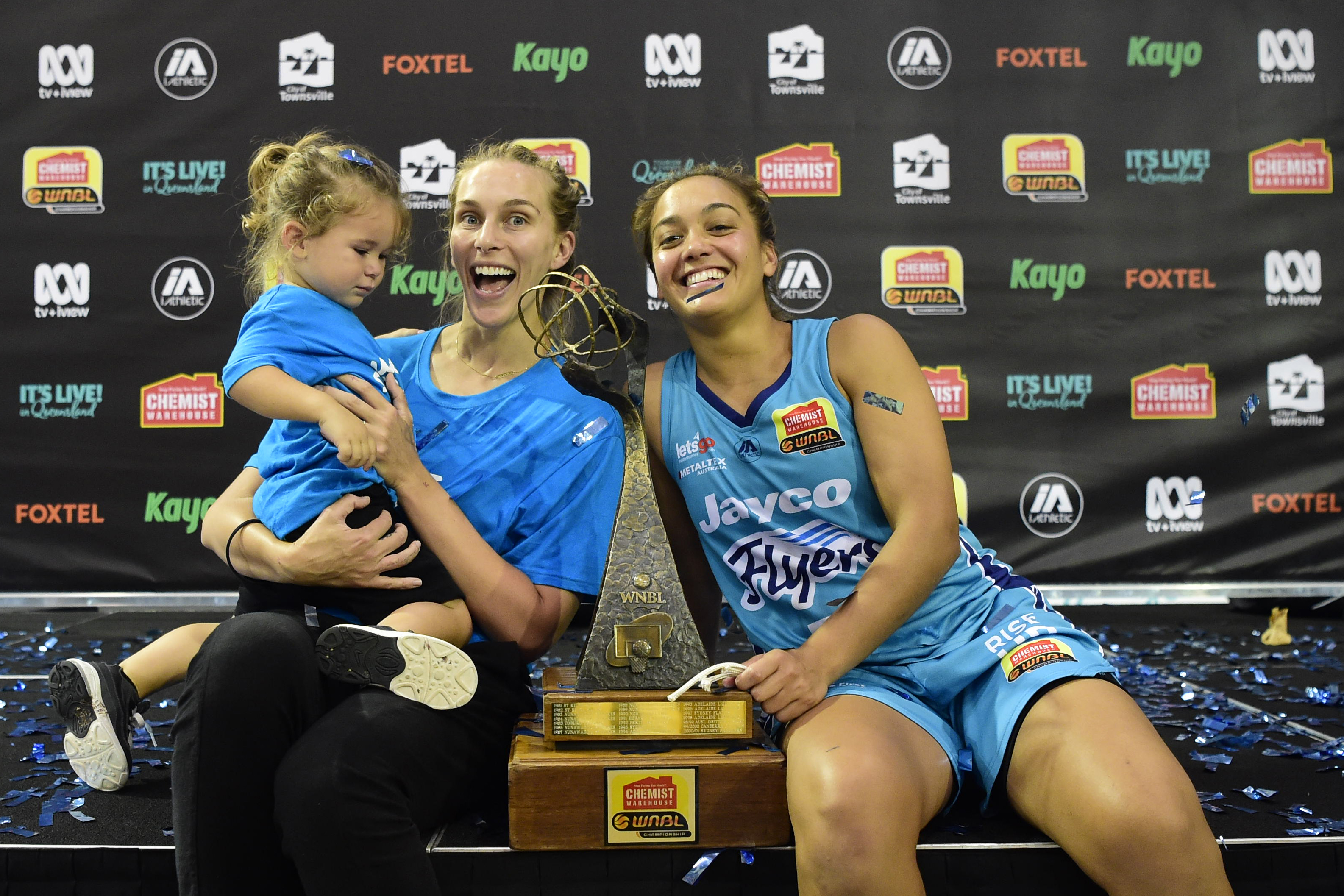 TOWNSVILLE, AUSTRALIA - DECEMBER 20: Leilani Mitchell of the Flyers celebrates with partner Mikaela Dombkins and son Kash after winning the WNBL Grand Final match between the Southside Flyers and the Townsville Fire at the Townsville Stadium, on December 20, 2020, in Townsville, Australia. (Photo by Ian Hitchcock/Getty Images)