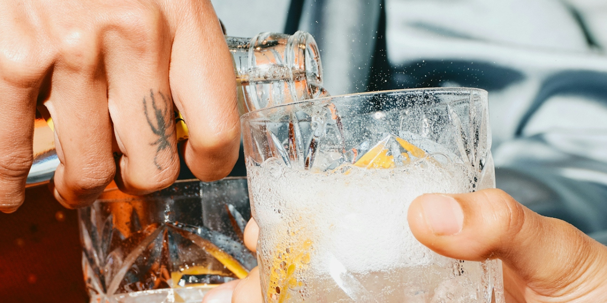 someone pouring a glass at a bar