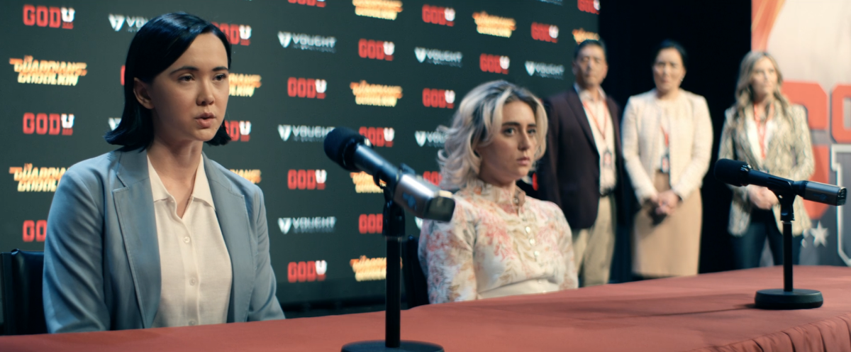 Gen V 201: Jordan and Emma sit at a press conference table looking miserable.