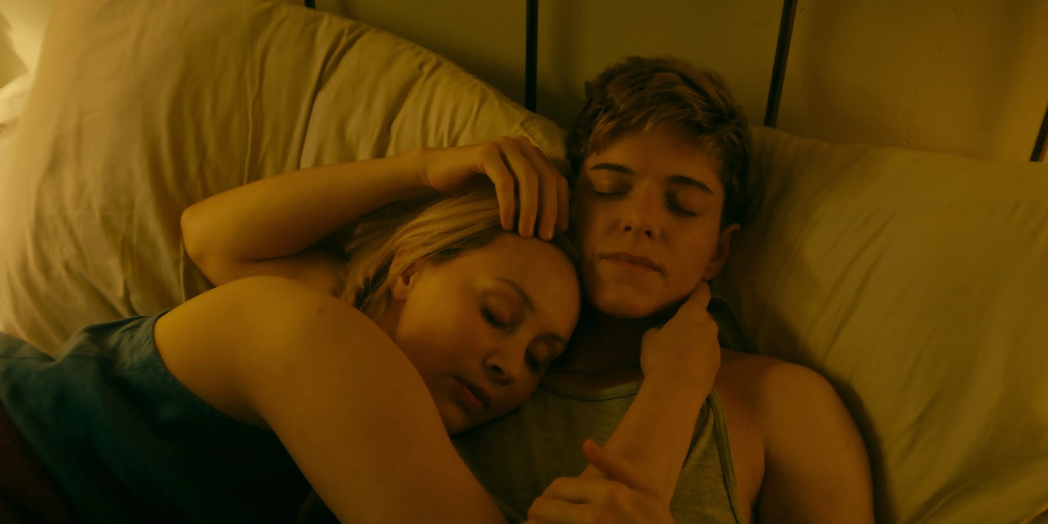 Sarah Gadon and Mae Whitman in a bed in Wayward