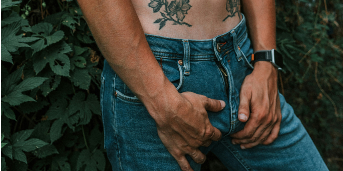 a trans guy holding his bulge