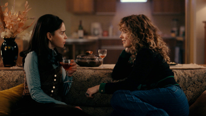 Ponies: Bea and Twila sit on the couch, facing each other and chatting