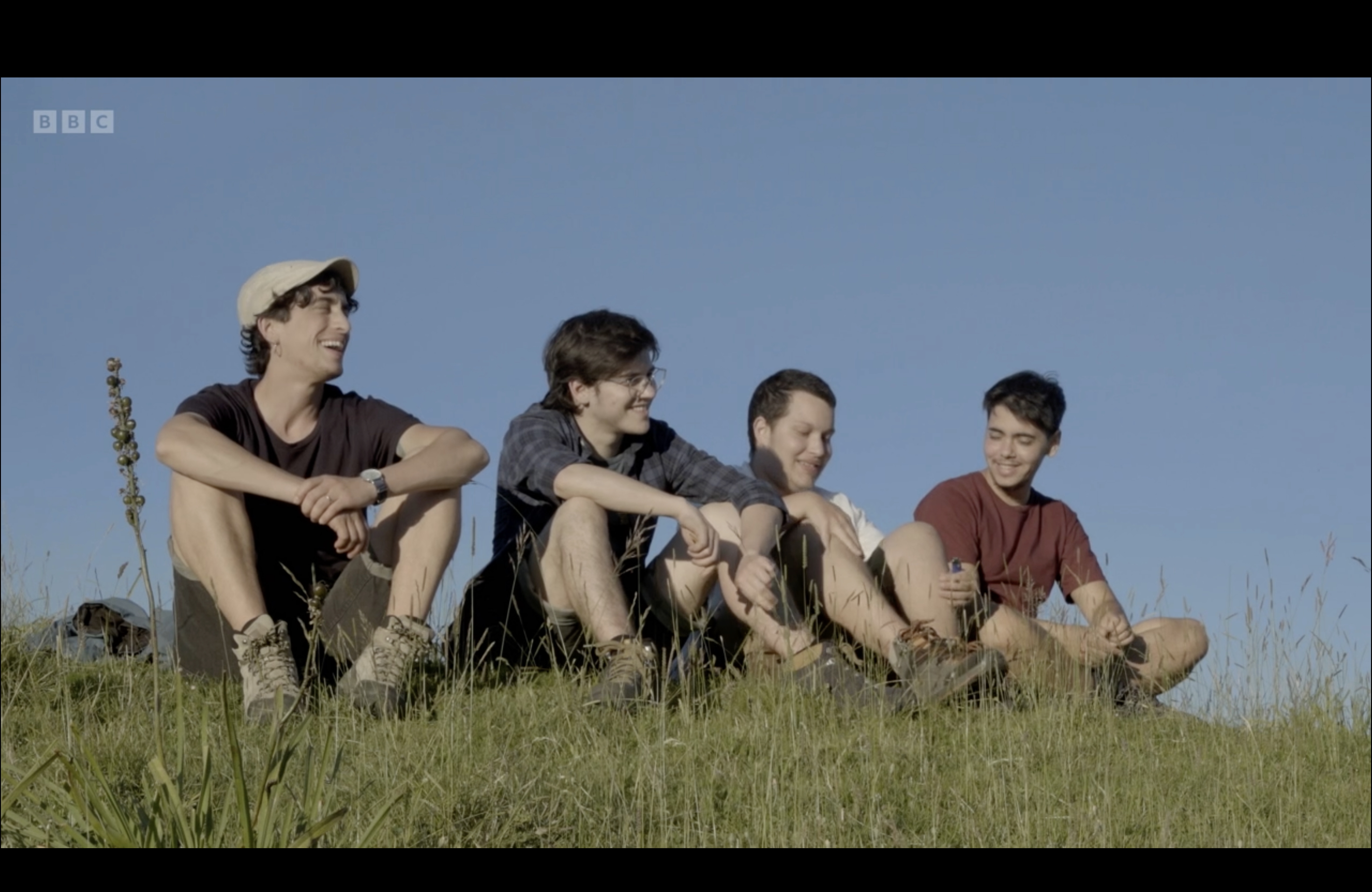Into my name — four guys smiling laughing outside