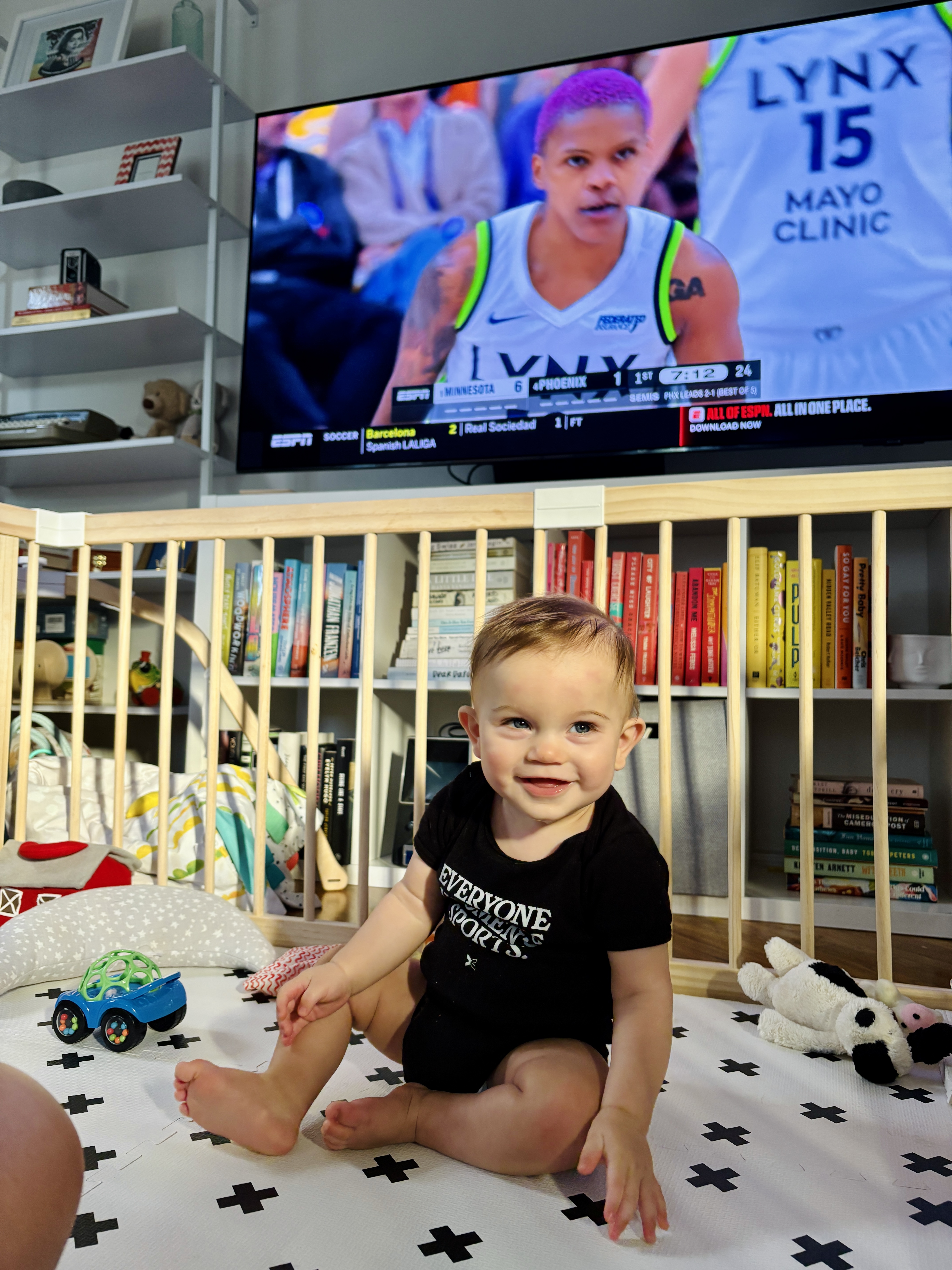 baby with basketball on in the bakcground
