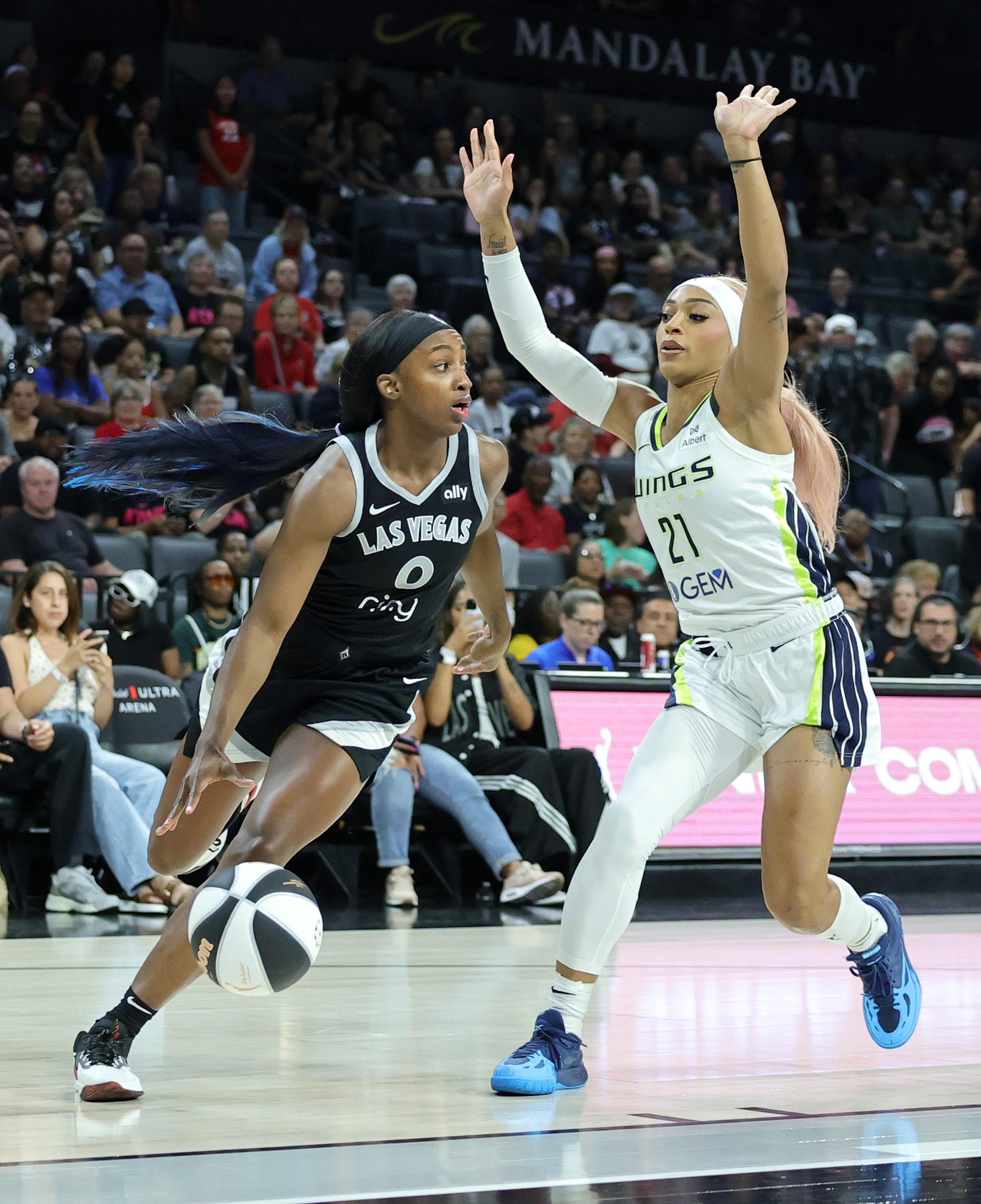 LAS VEGAS, NEVADA - JUNE 13: Jackie Young #0 of the Las Vegas Aces handles the ball against DiJonai Carrington #21 of the Dallas Wings in the first quarter of their game at Michelob ULTRA Arena on June 13, 2025 in Las Vegas, Nevada. The Aces defeated the Wings 88-84. NOTE TO USER: User expressly acknowledges and agrees that, by downloading and or using this photograph, User is consenting to the terms and conditions of the Getty Images License Agreement. (Photo by Ethan Miller/Getty Images)