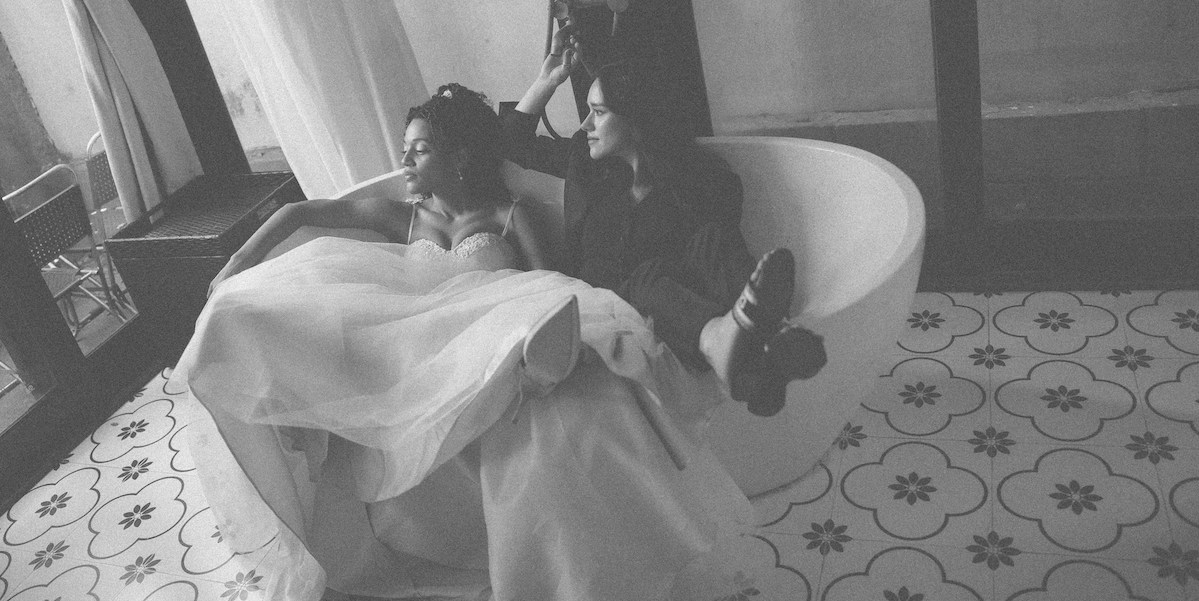 two women in a bathtub after a wedding