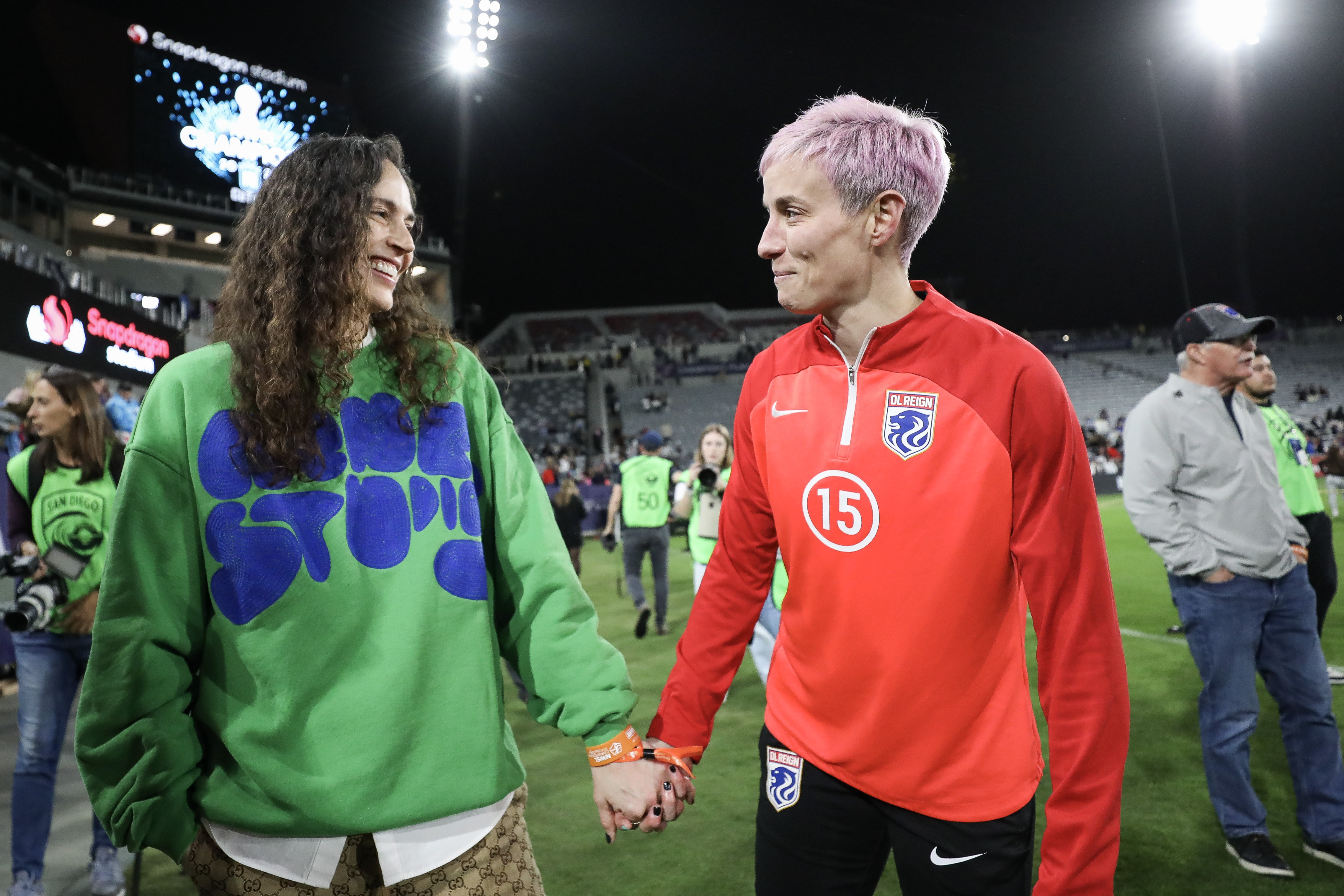 SAN DIEGO, CALIFORNIA - NOVEMBER 11: Megan Rapinoe #15 of OL Reign holds hands with Sue Bird after losing to NJ/NY Gotham FC in the 2023 NWSL Championship game at Snapdragon Stadium on November 11, 2023 in San Diego, California. (Photo by Meg Oliphant/Getty Images)