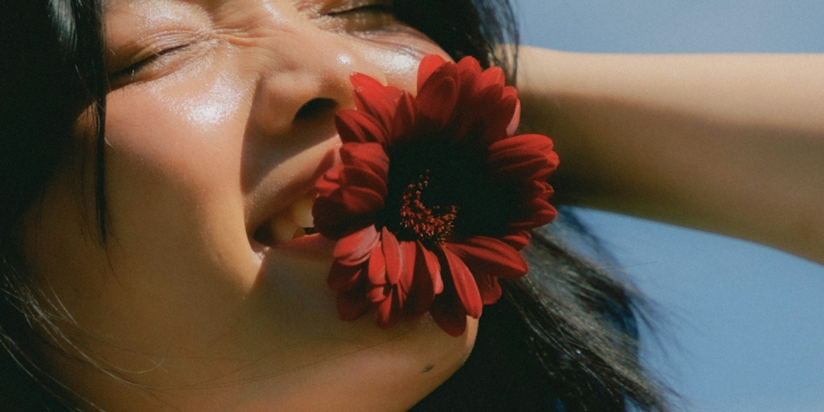 a person with a flower in their mouth