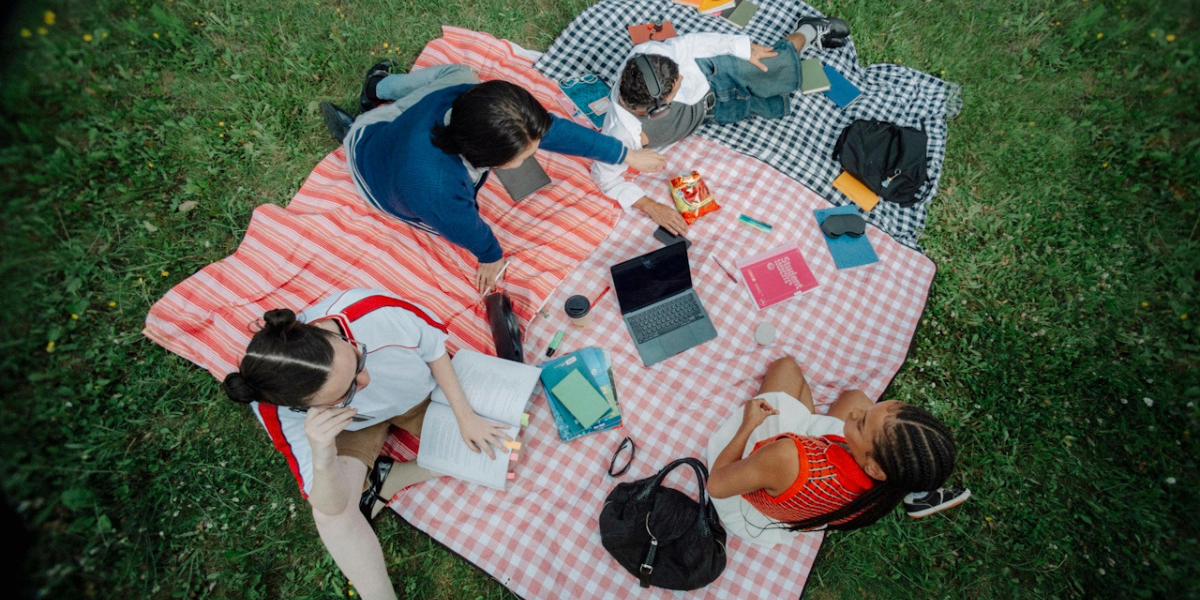 a group of friends on a picnic blanket