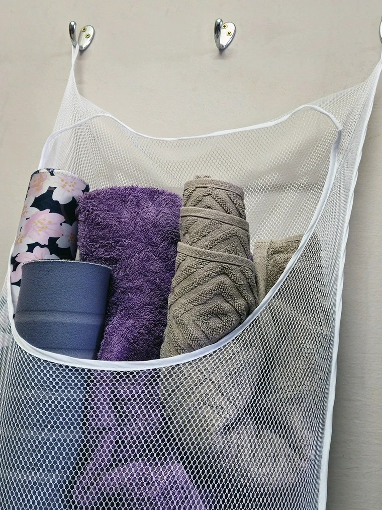 Spare mouse mats, bathmats, and floor towels hang in easy reach. Dirty ones get replaced and washed weekly for minimal effort.