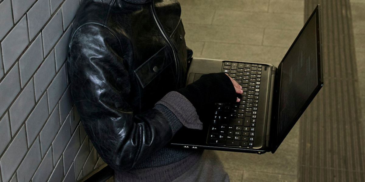 a person on a computer in the subway